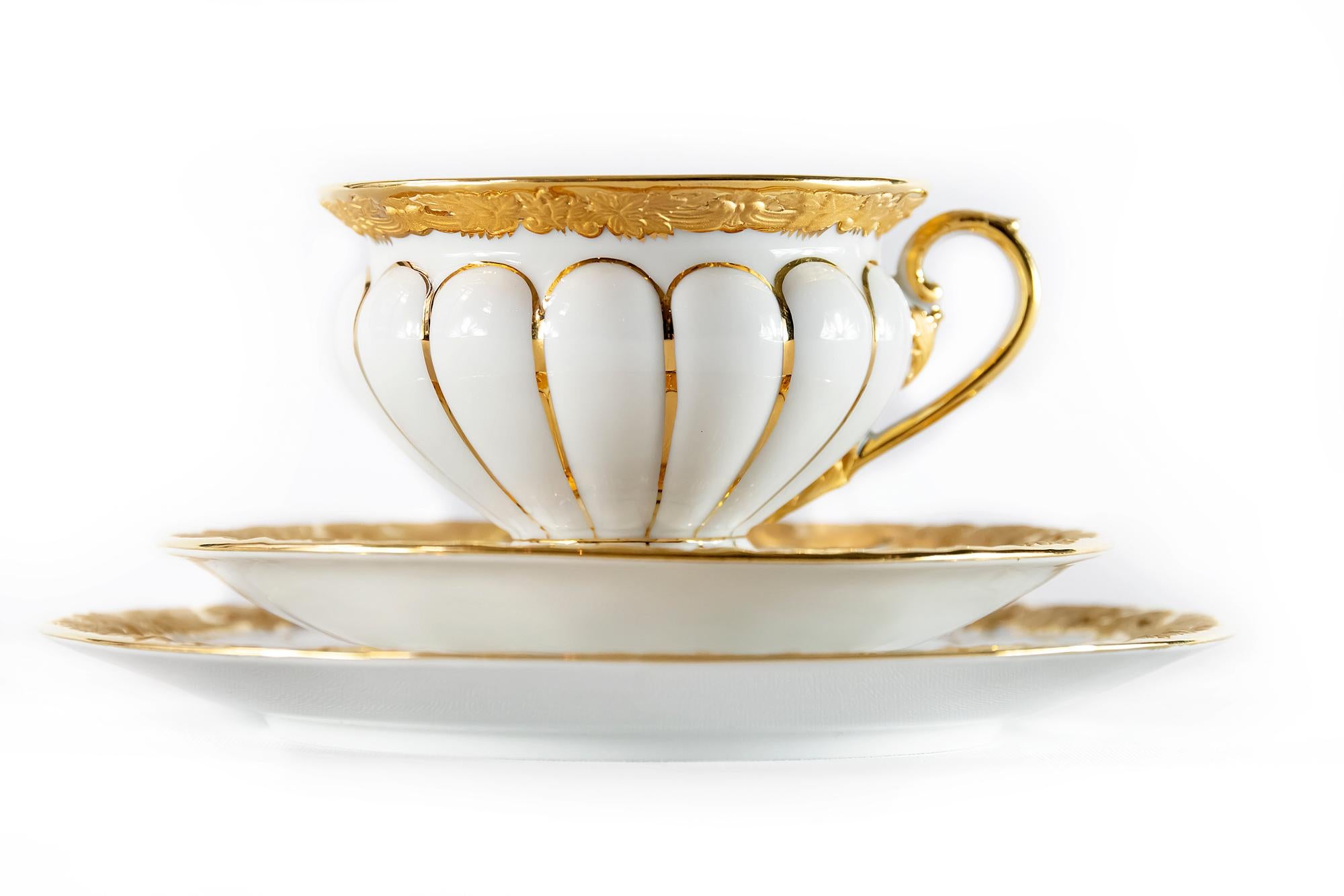 Meissen porcelain tea cup with saucer and dessert plate all richly decorated with gold.
Measures:
Cup: 7.2 (H) x 10 cm
Saucer: 15.5 cm
Dessert plate: 19.5 cm.
 