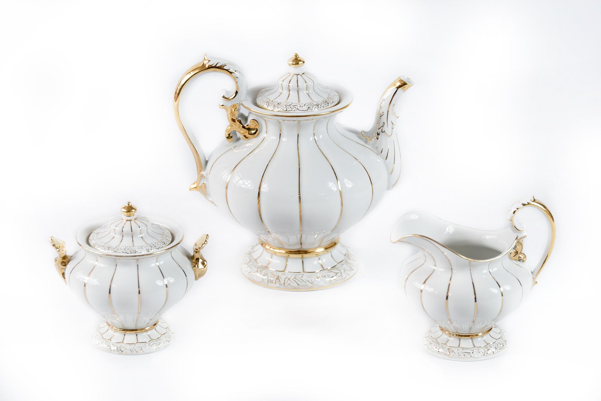 German Meissen porcelain tea set of 3 pieces. Including teapot, milk jug and sugar bowl.
Porcelain is hand painted with gold.
Dimensions of the teapot: 21 x 22 cm.
The logo indicate a porcelain of second-quality grading.
