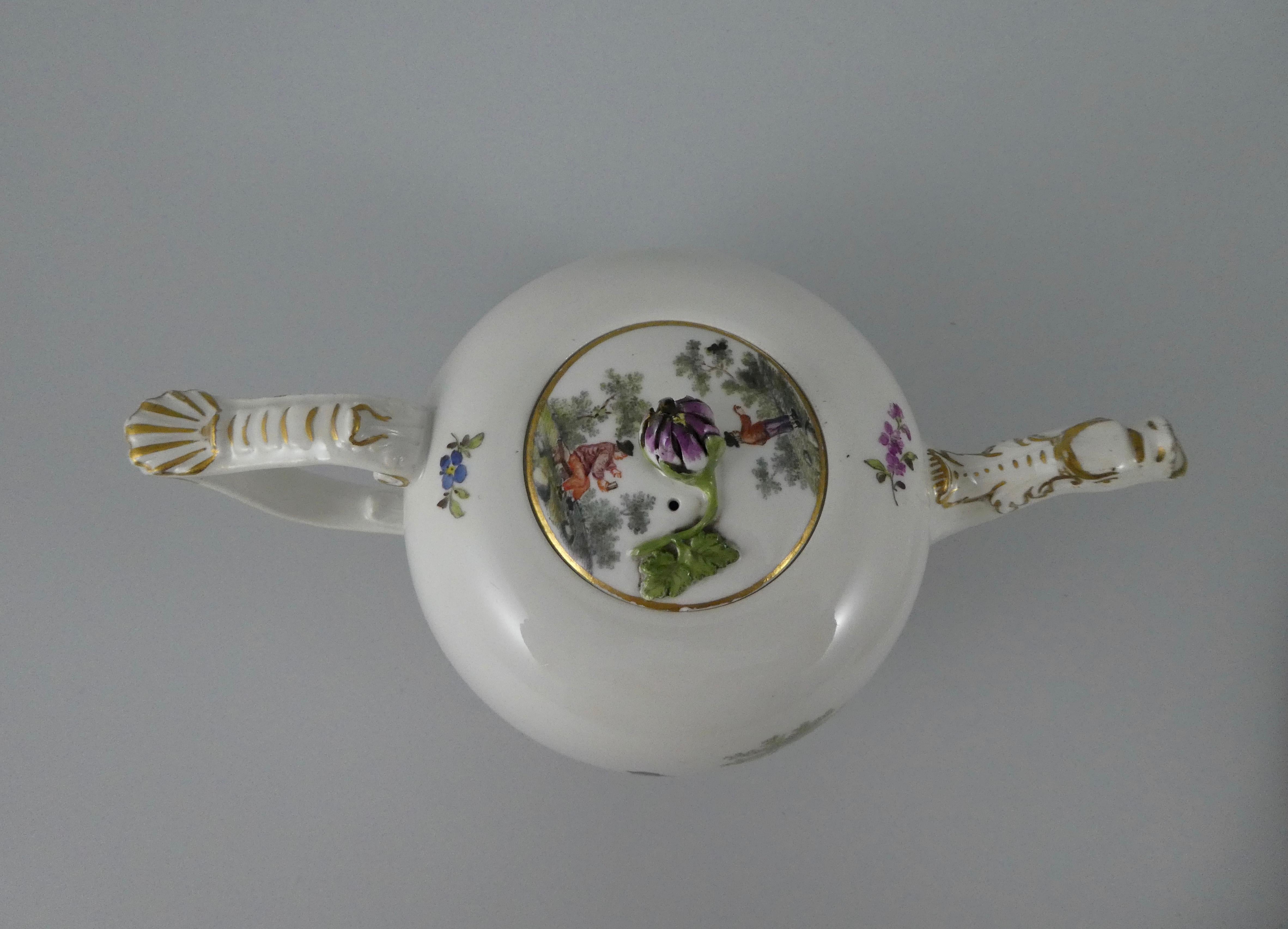 A fine Meissen porcelain teapot and cover, circa 1740. Well painted with scenes of peasants going about their daily life, in rural landscapes, after Teniers. Interspersed with floral sprays. The teapot has a spout moulded as a mythical beast, and a