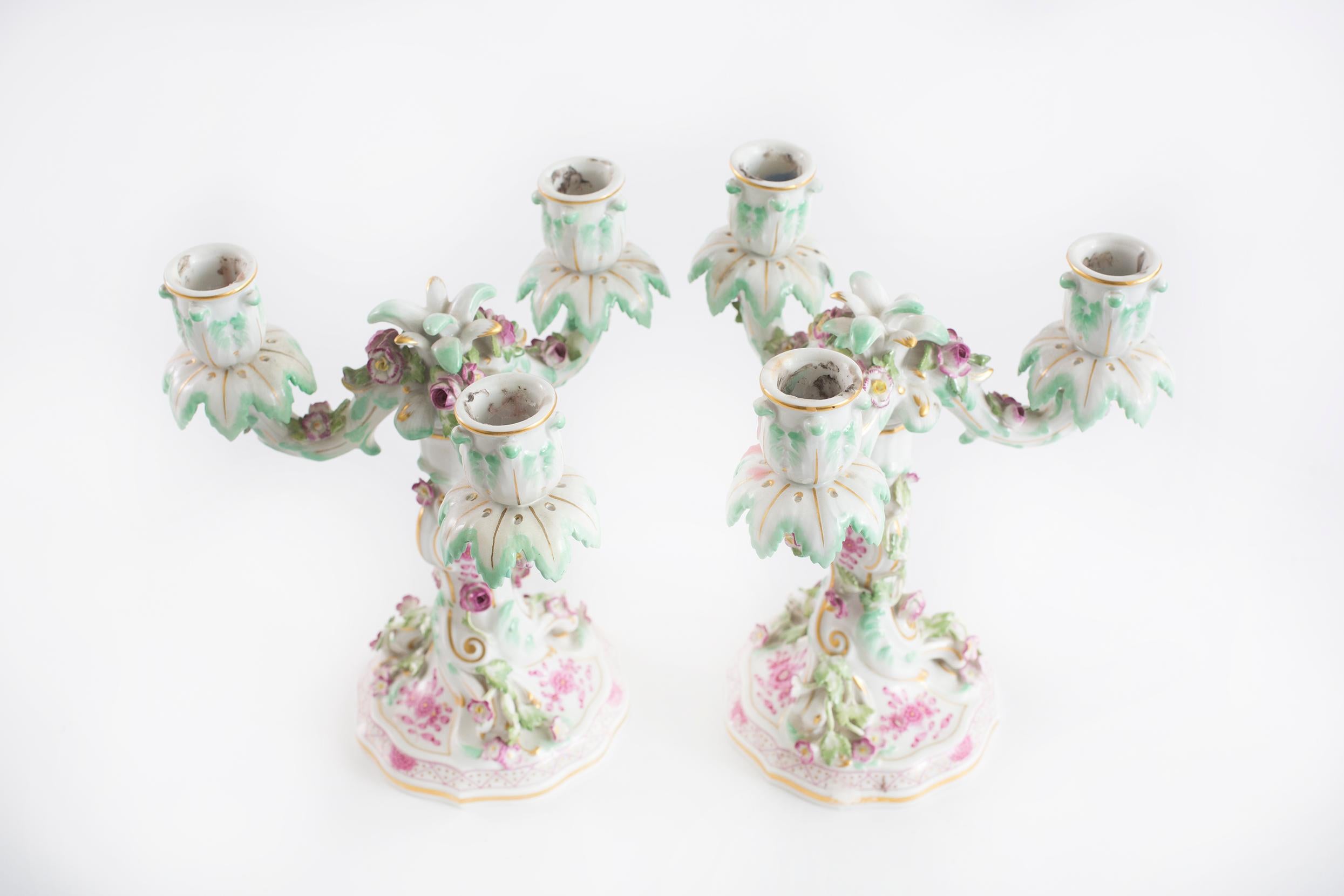 Beautiful pair Meissen blue crossed swords porcelain pair three arms candle holder with exterior floral design details. Each one is in great condition. Maker's mark undersigned. Minor wear consistent with age / use. Each one stand about 9 1/2 inches