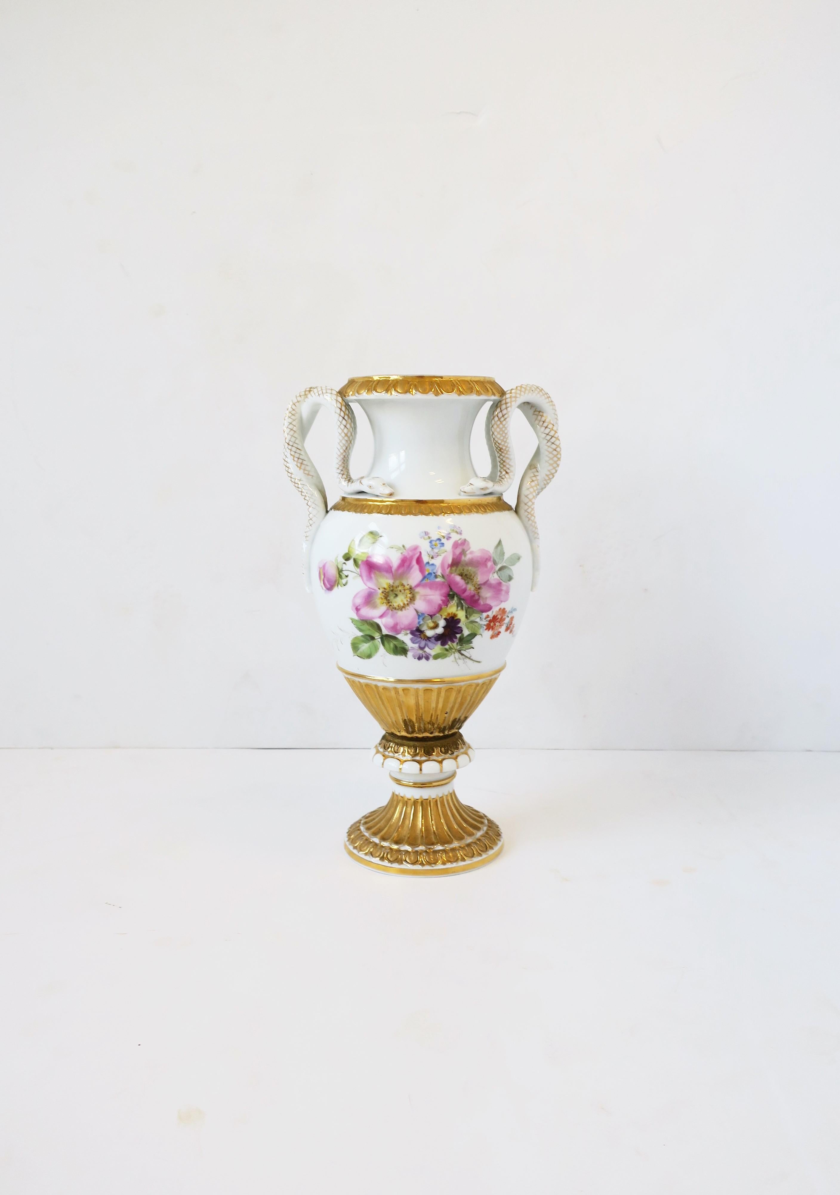 An antique Meissen porcelain urn with snake handles amphora, circa early-20th century, Germany. This Meissen urn is hard-paste porcelain, hand painted, featuring two different floral motifs, scrolled snake handles with 'snakeskin' detail in gold,