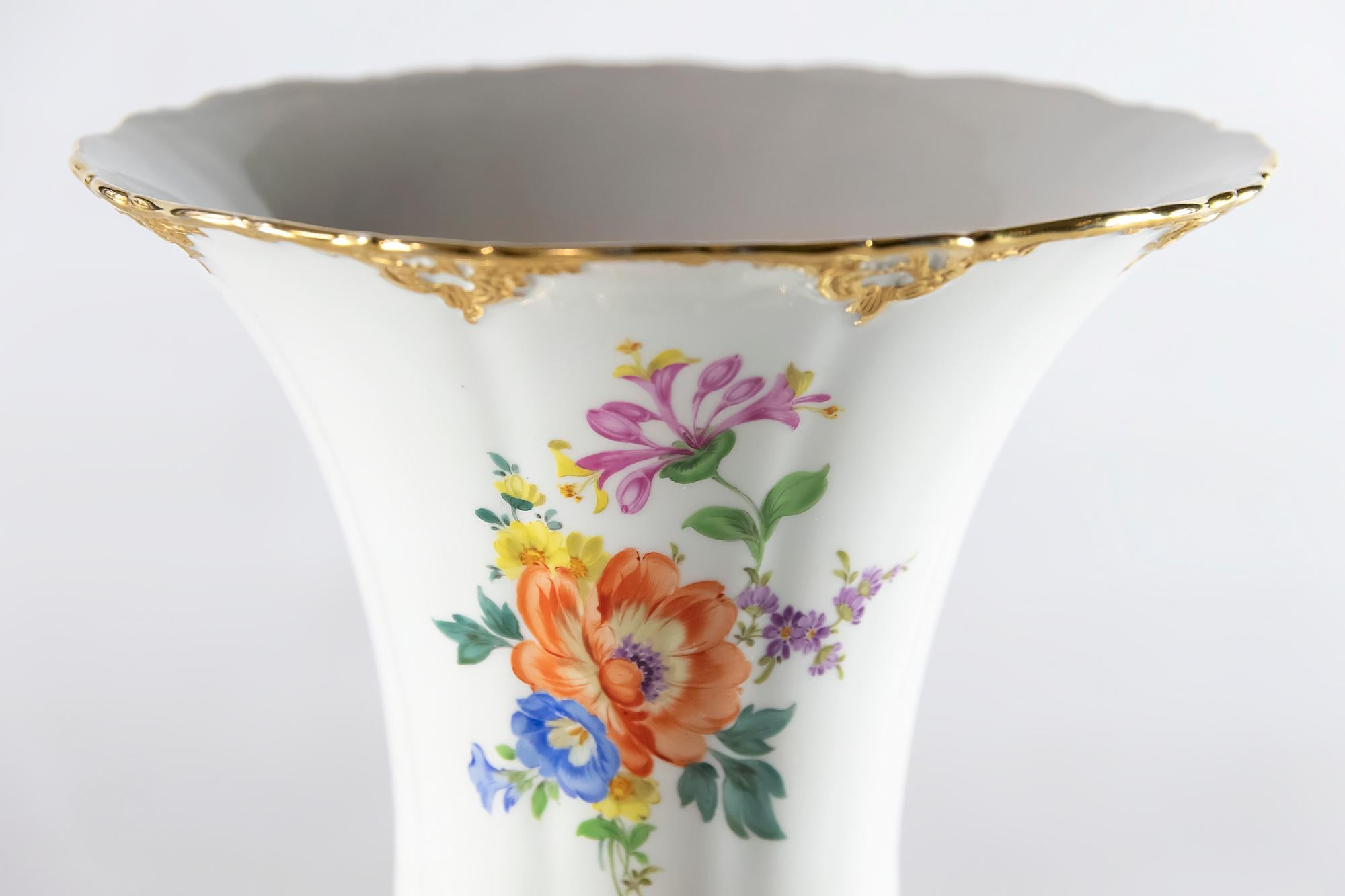 Meissen Porcelain vase with hand painted flowers and decorated gold ornaments.