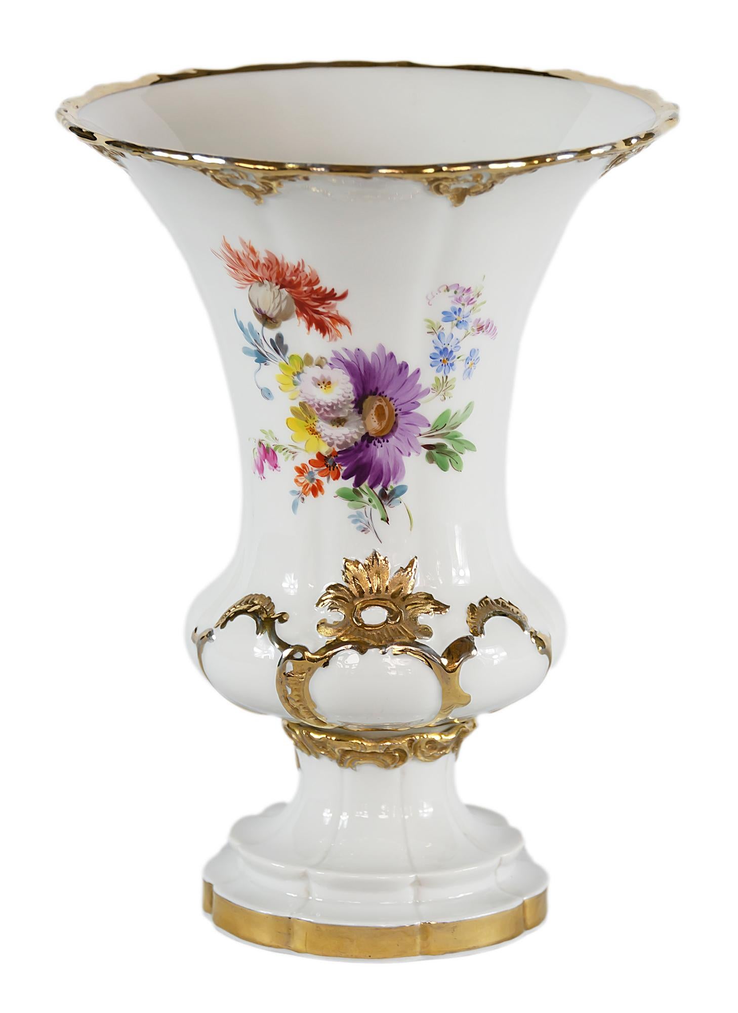 Meissen Porcelain vase with hand painted flowers decorated with gold ornaments.