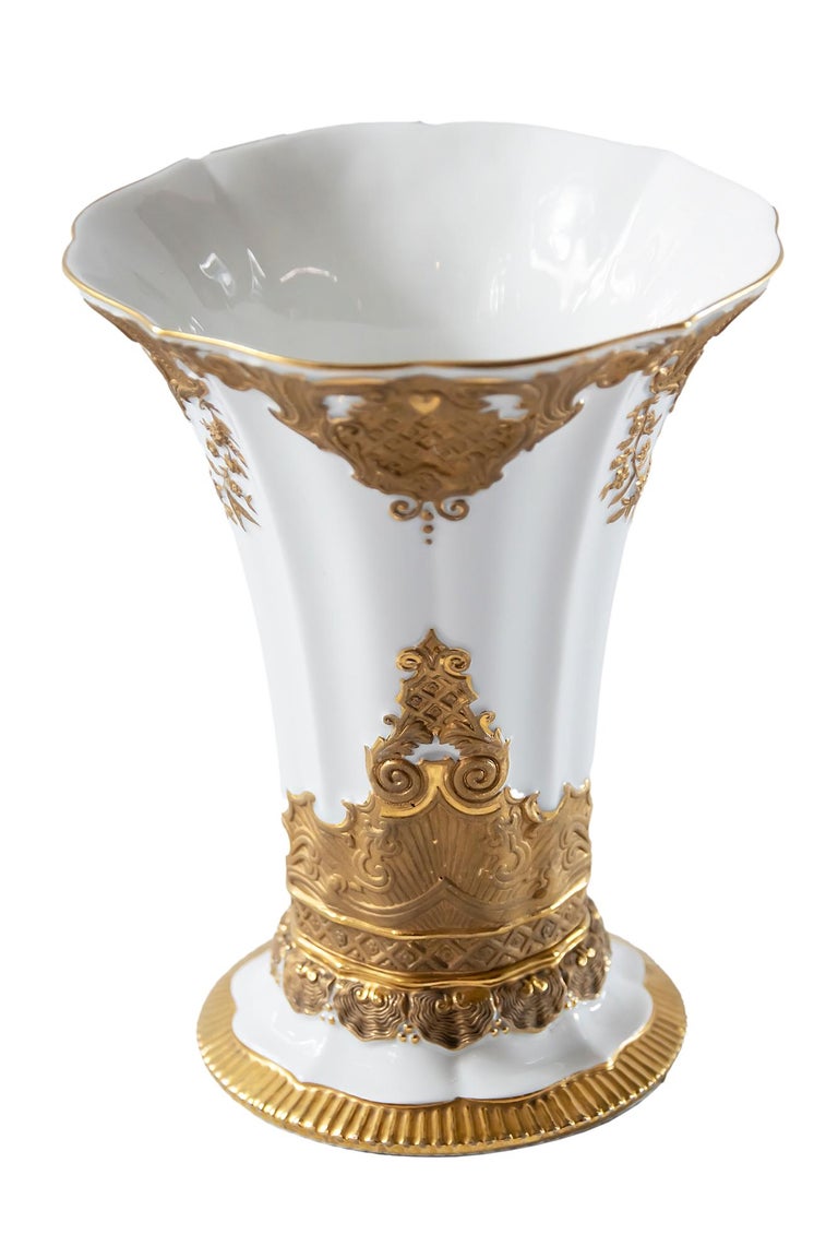 Meissen Porcelain vase with hand decorated gold ornaments.