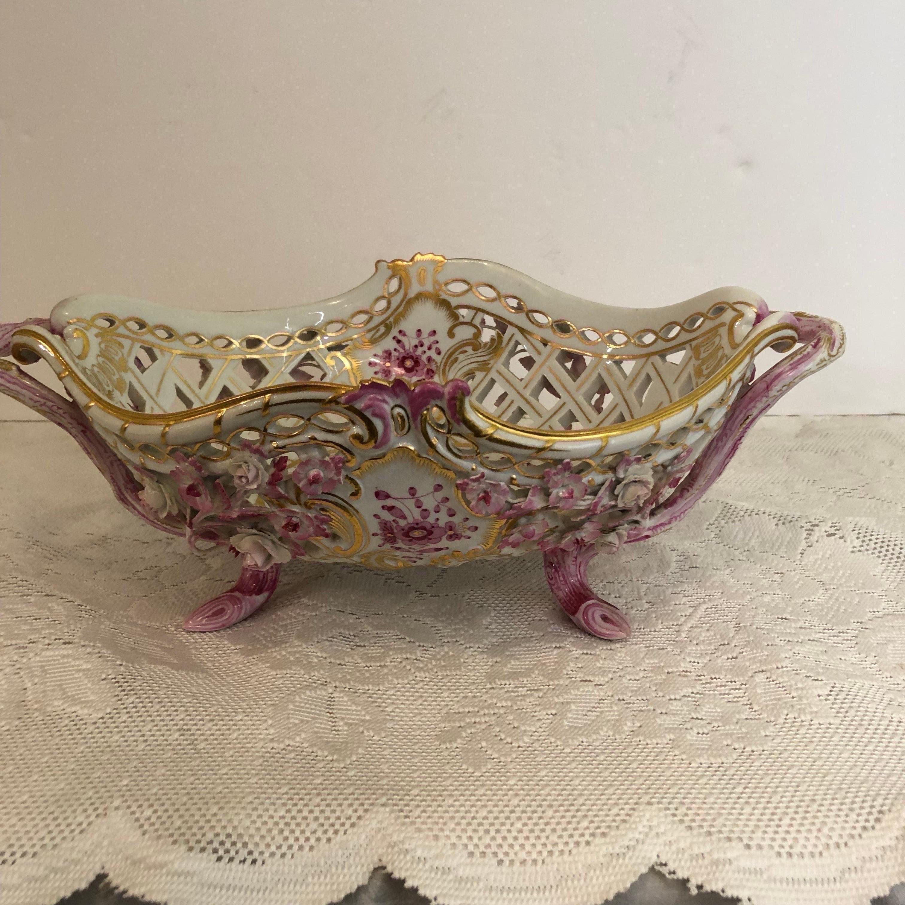 We are offering you this rare exquisite, reticulated Meissen centerpiece bowl in the beautiful purple Indian pattern. This fabulous centerpiece is encrusted with raised pink flowers all over the outside of this bowl. It has pink tree trunk shaped