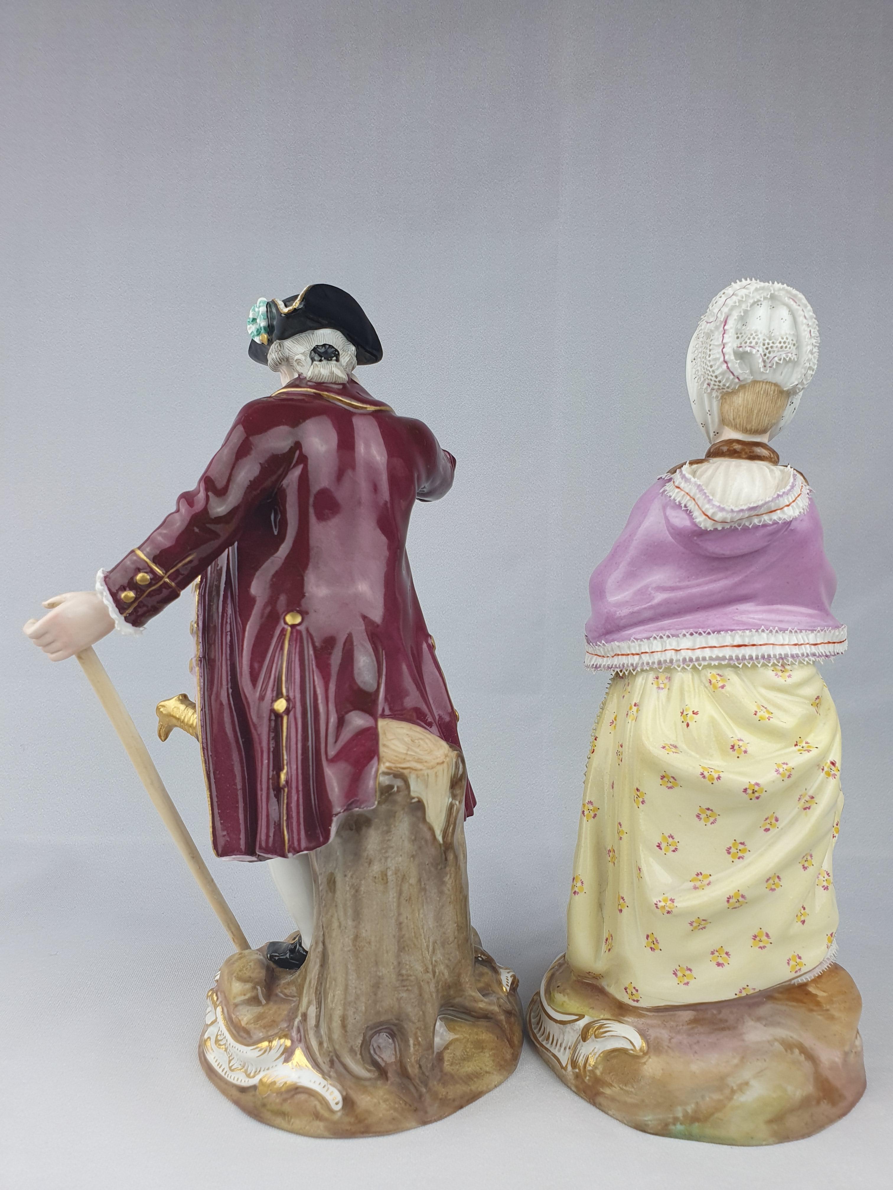 A pair of Meissen figures of the Racegoer and his companion, holding his spyglass to his right eye, his left holding the top of his cane, his companion holding a letter and with her other hand tucked into a bright feathered muff. First modelled by