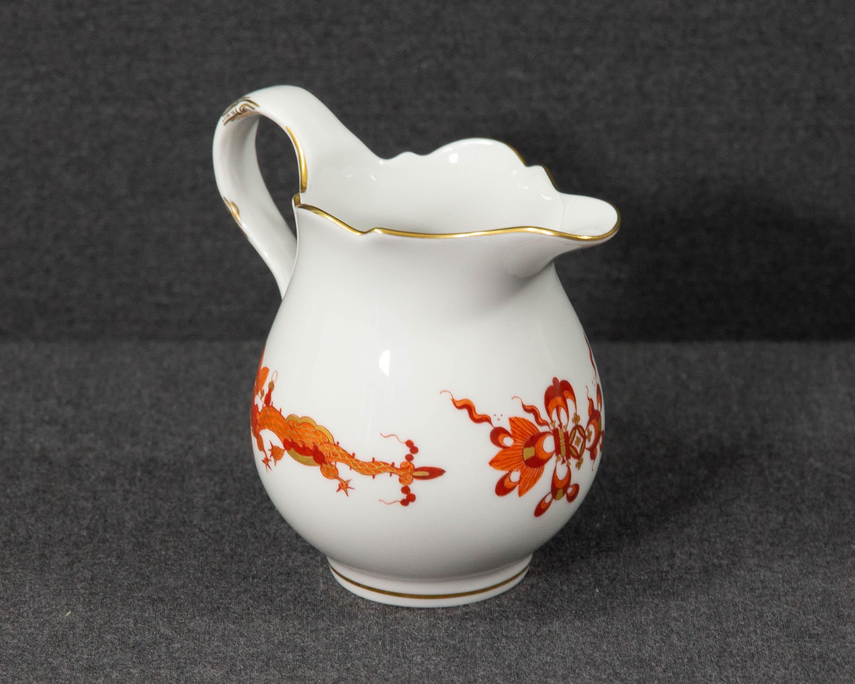 A Meissen red dragon milk jug.

The milk jug or creamer was made by Meissen and has been decorated with the 'Court Dragon' pattern in red. The item was made in the second half of the 20th century.

The item is made of white porcelain and is hand