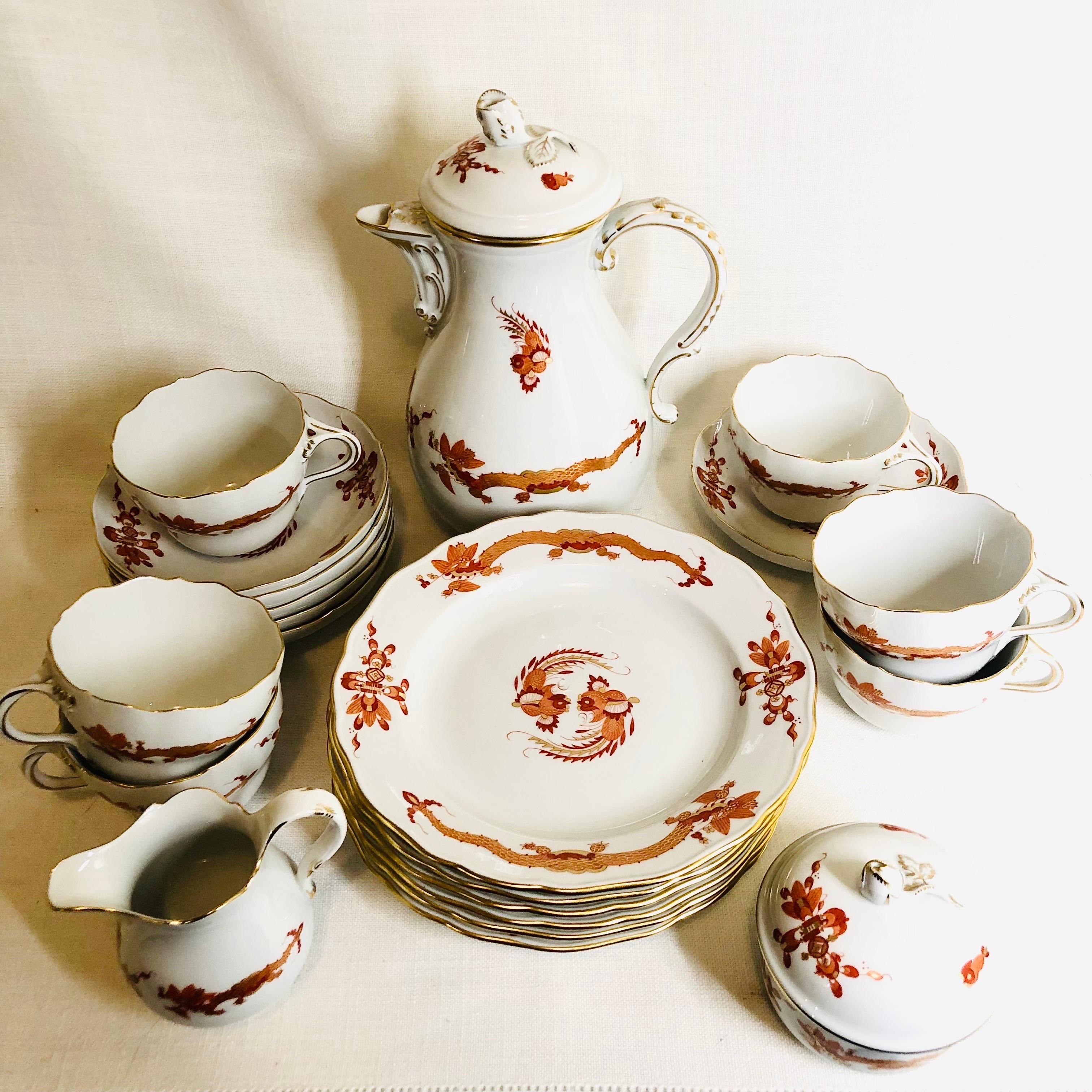 This is a fabulous Meissen rich court dragon tea or coffee set, which includes a tea or coffee pot, a sugar and creamer, six cake plates and six cups and saucers. Both the pot and the covered sugar have raised roses on their covers. All these pieces