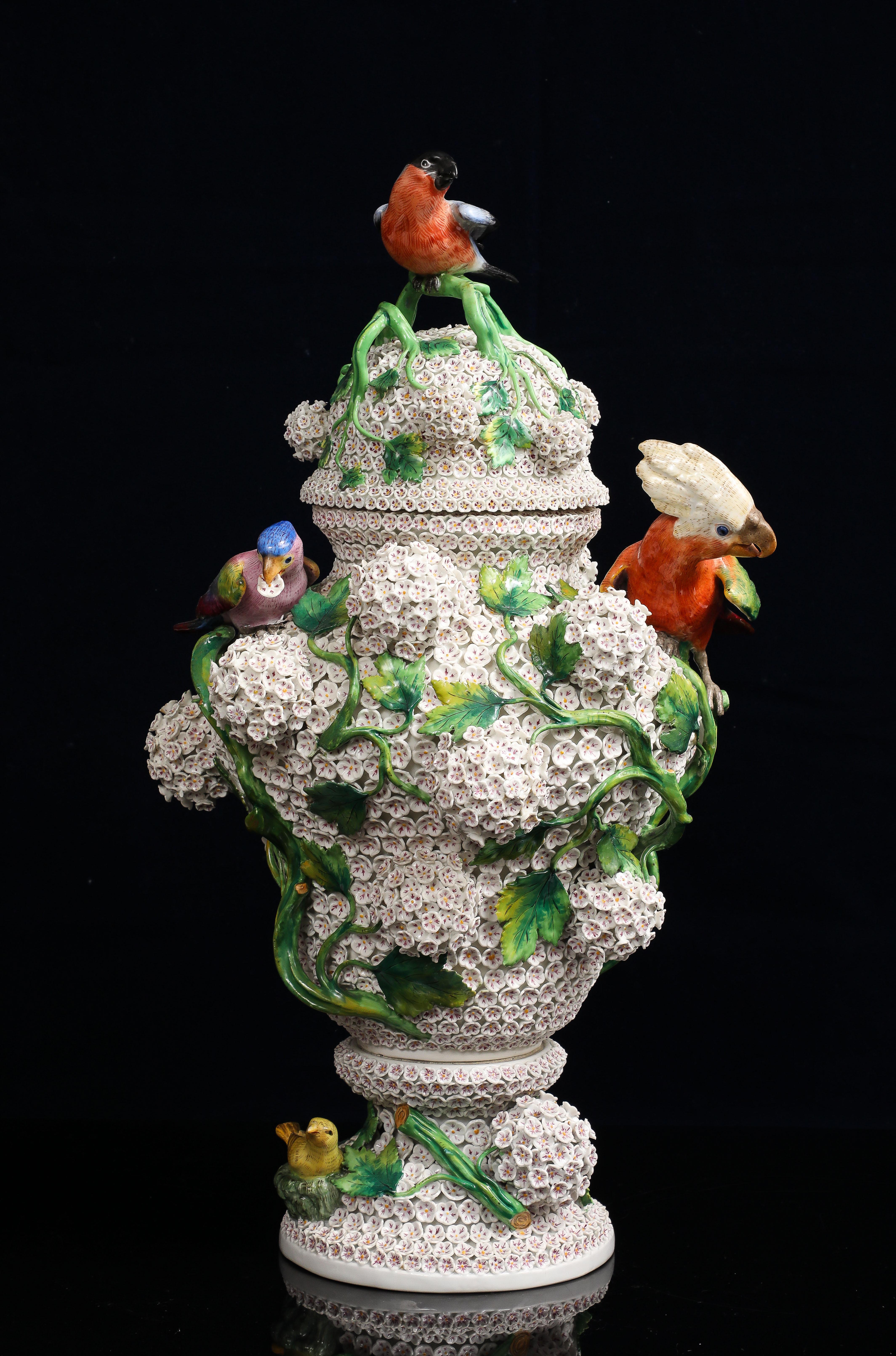 A magnificent and large Meissen Schneeballen (snowball) covered vase, richly adorned with a vibrant aviary and botanical ensemble in full three-dimensional relief. Crafted in the mid-to-late 19th century, this monumental porcelain masterpiece is a