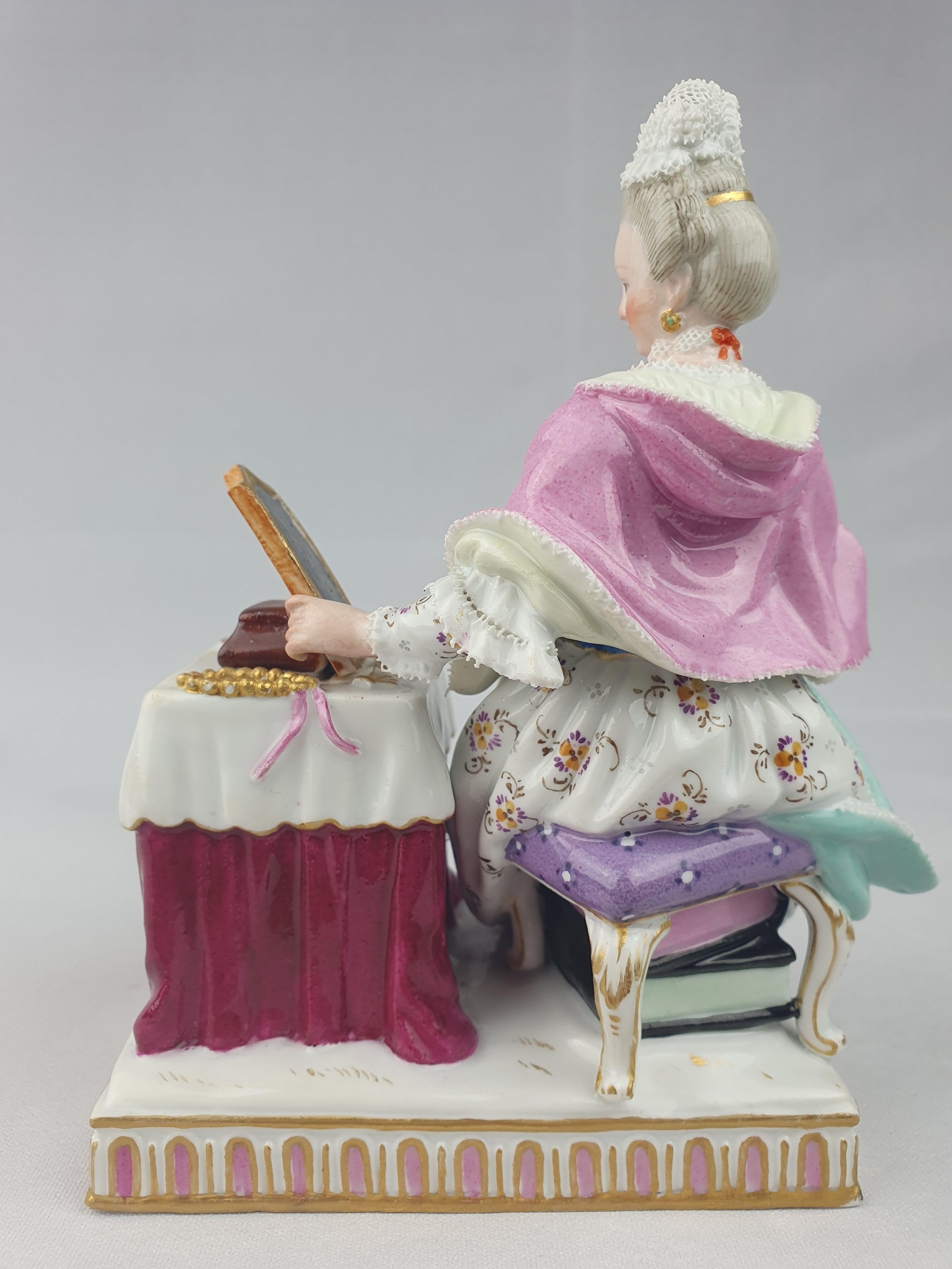 Meissen Figure of Sense of Sight from the series of the five senses themed with a pink shawl. Model number E3.

First modelled by J.C Schoenhelt in 1772.

Height is 14cm.

Underglaze blue crossed swords on underside of base.

Circa 1860.

