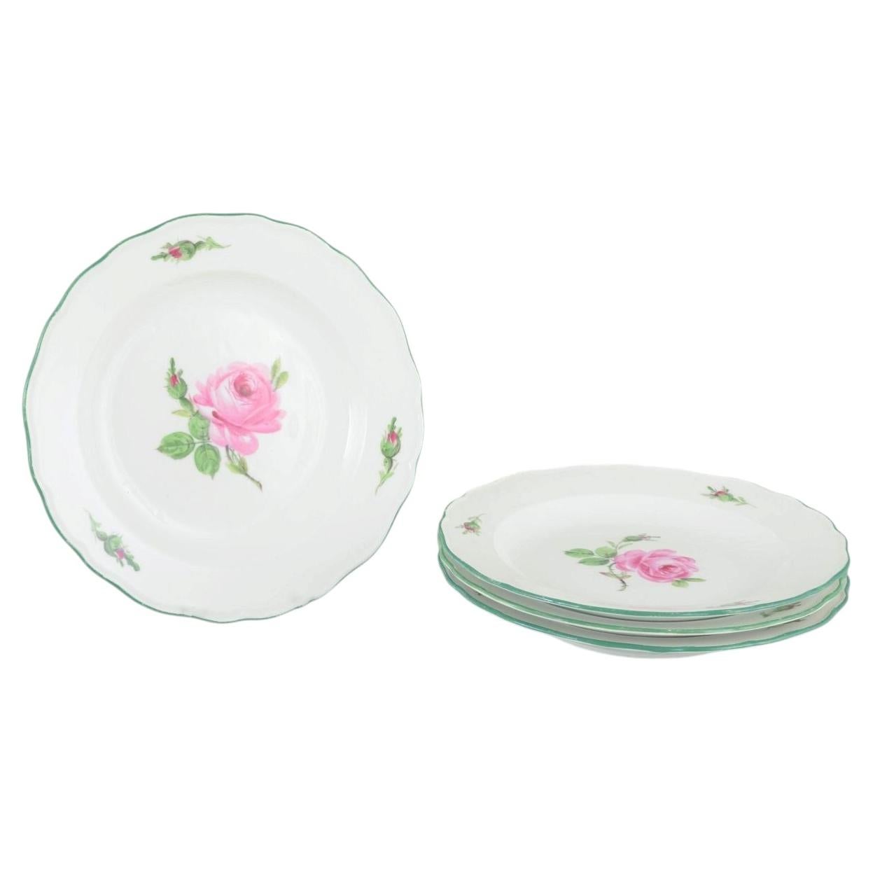 Meissen. Set of four porcelain plates with pink roses and green rim. 1930s