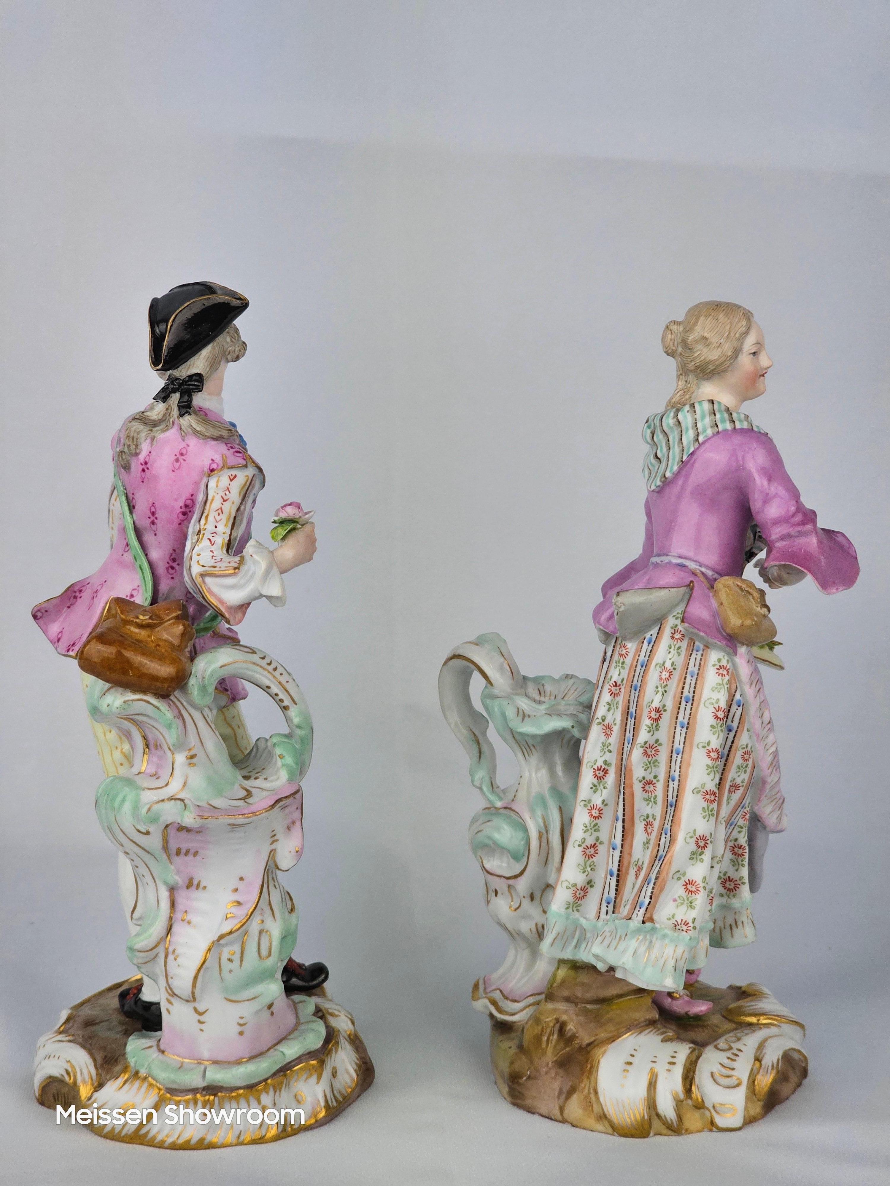 Meissen Shephard and Shepherdess collecting fruit next to large ewer First modelled by Meyer in 1760.

Circa 1860
Model number is 1776 and 1774.
Underglaze Blue crossed swords