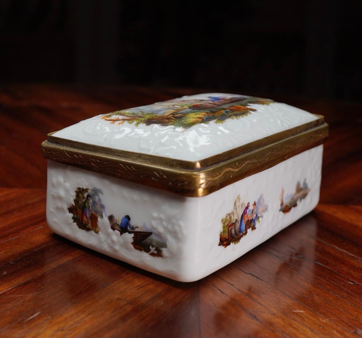 Meissen snuff box of rectangular form, finely painted with fishing scenes to all surfaces, set within flower moulded borders, the inside lid with a delightful scene of a lion and children, the interior gilt.
Period gilt metal mounts with incised
