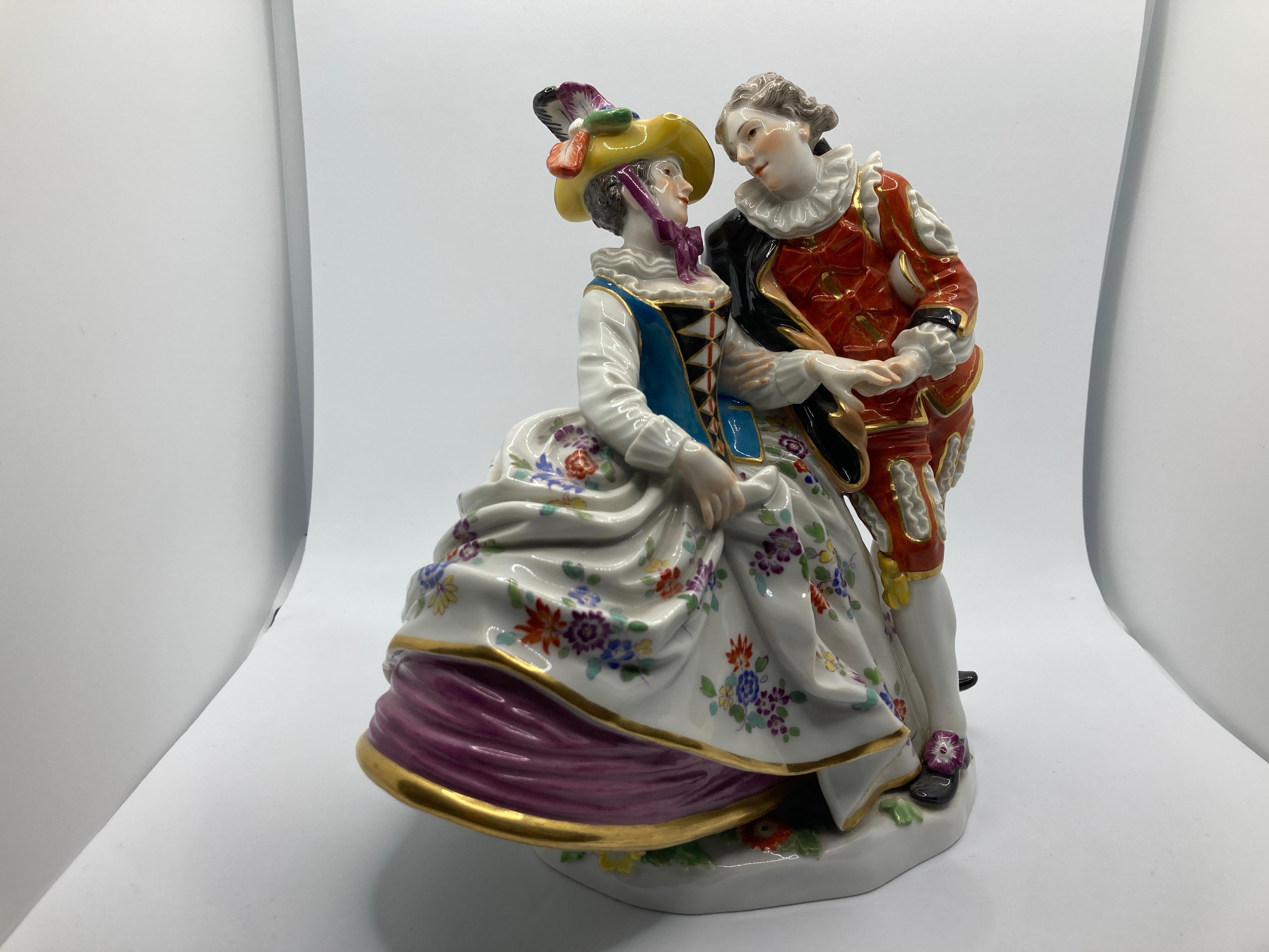 Meissen figure group of 'Spanish Lovers' 

The girl with blue bodice and floral pattern skirt, her companion with red coloured jacket and matching gilt-edged knee breeches, underglaze blue crossed swords, incised 230, 20th century version.

Original
