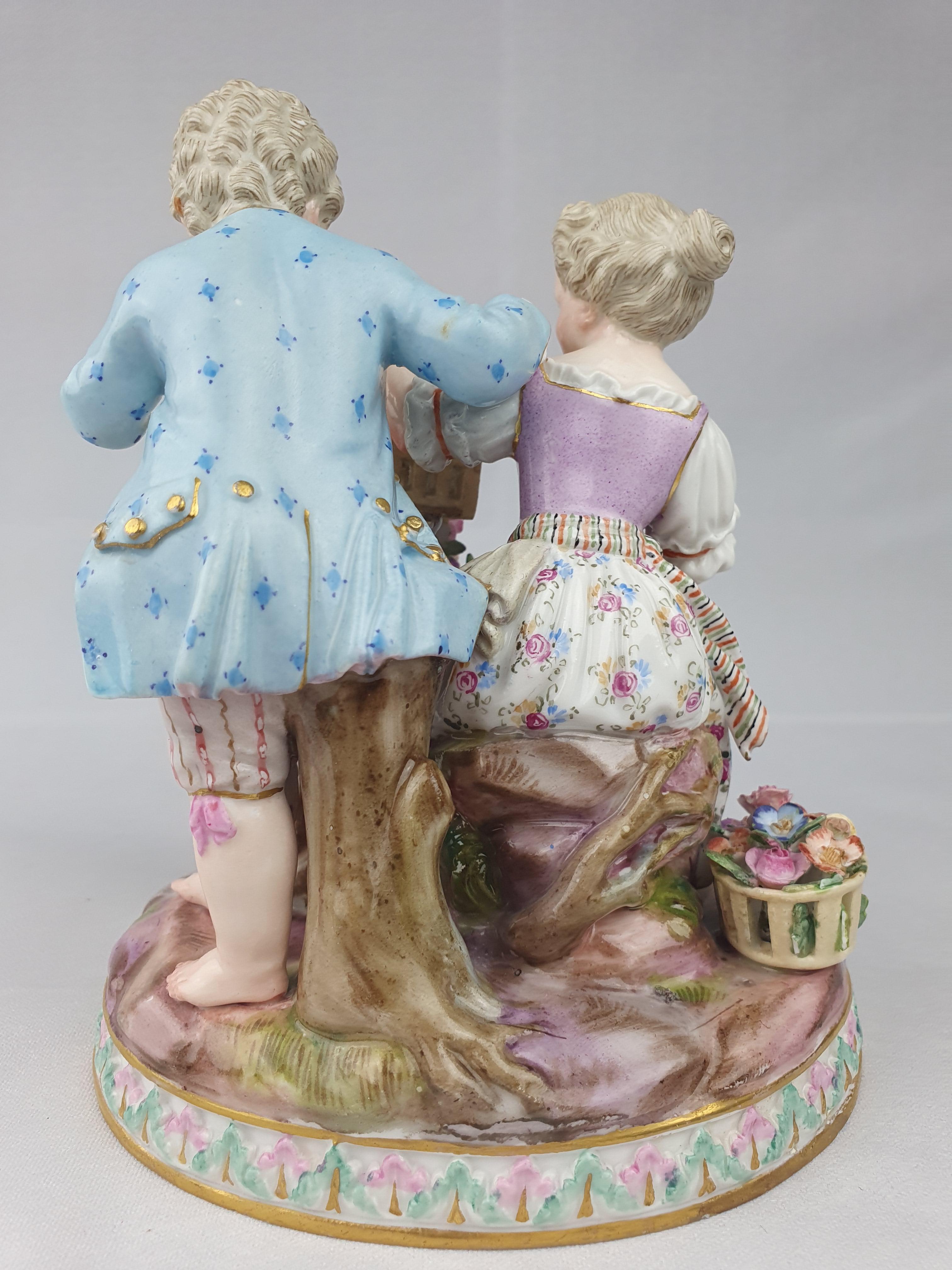 Meissen group Allegory of Spring (Der Frühling). First modelled by Johann Carl Schönheit in 1782. Two children with birdcage and garland of flowers.

Impressed G91, painters Mark 67. Blue Crossed Swords.
