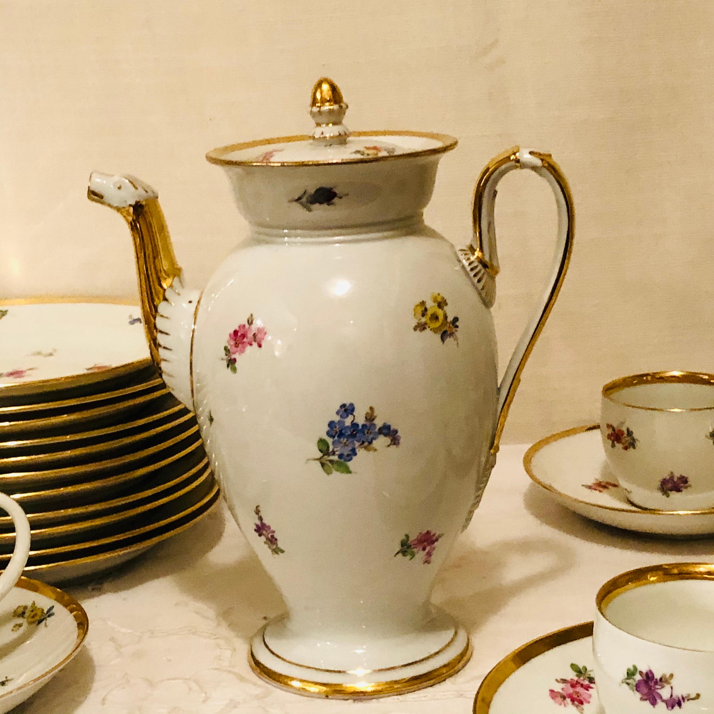 This is a wonderful Meissen streublumen tea set with 10 teacups and saucers, 10 cake plates and a teapot. The cups have enchanting animal handles and the teapot has an animal spout. All the pieces have thick gold borders. Streublumen means thrown or