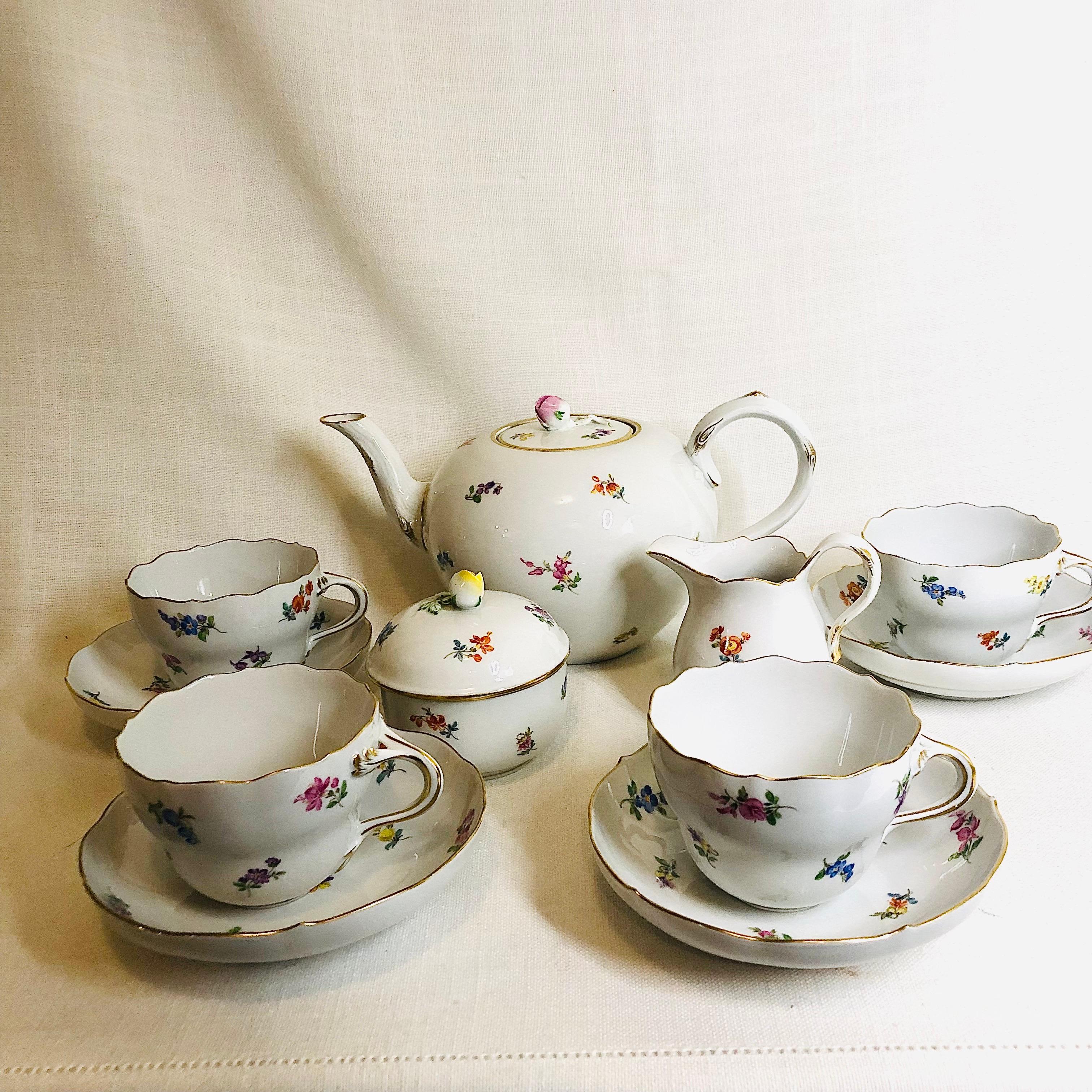 This is a beautiful Meissen streublumen tea set. It has a teapot, a sugar and a creamer and four cups and saucers. The teapot and the covered sugar have raised roses on top, as you can see in the pictures. The streublumen pattern stands for thrown