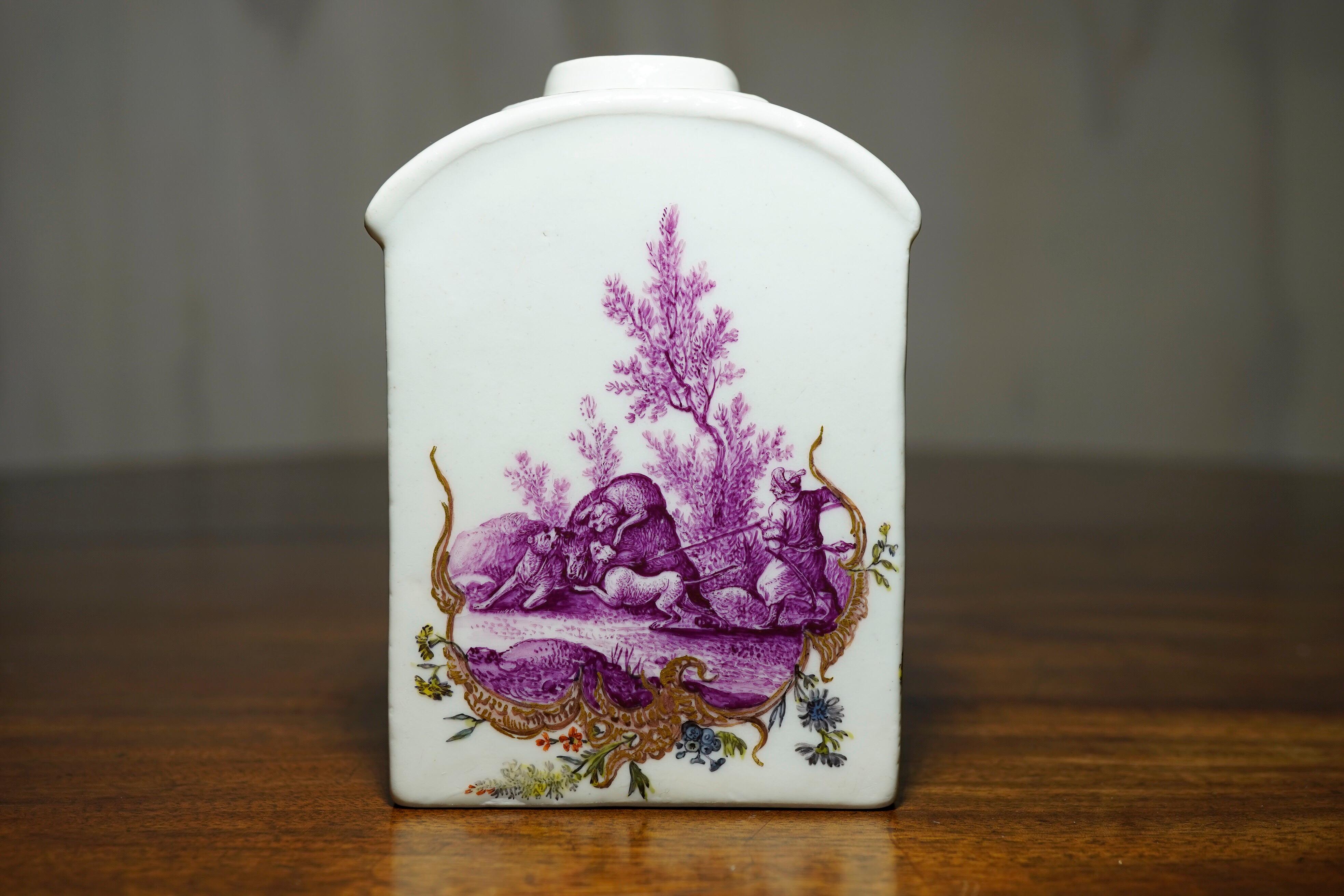 Meissen tea canister, superbly painted in purple with hunt scenes to each side, an elaborate gilt Rococo scroll to the lower portion of each scene.

Crossed swords mark, circa 1755.