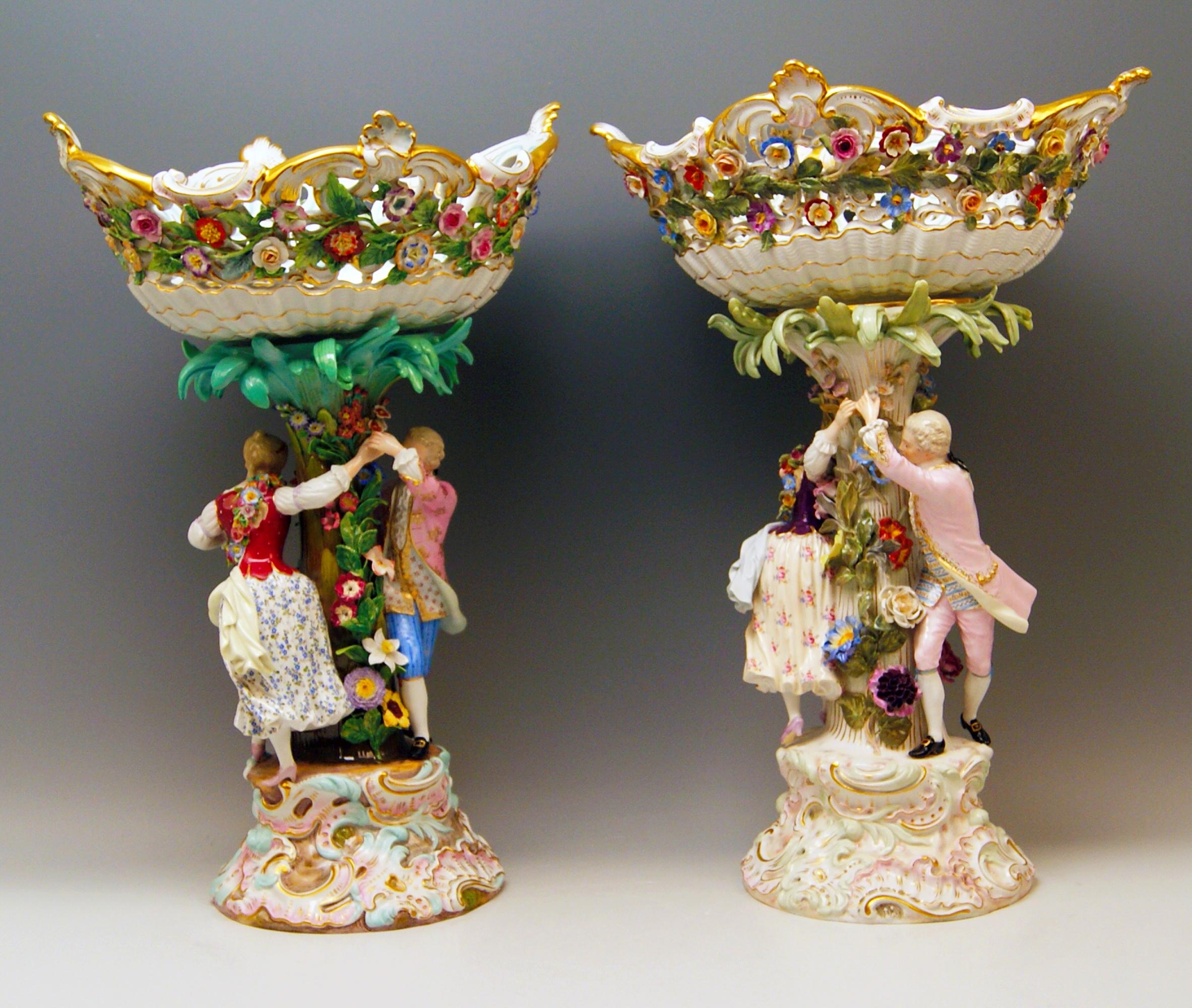 Meissen a pair of most remarkable tall centrepieces / fruitbowls:
Each of them decorated with a pair of rococo gardeners (male and female), circa 1870

Measures / Dimensions: 
height: 49.0 cm / 19.29 inches 
width of bowl: 35.0 cm / 13.77