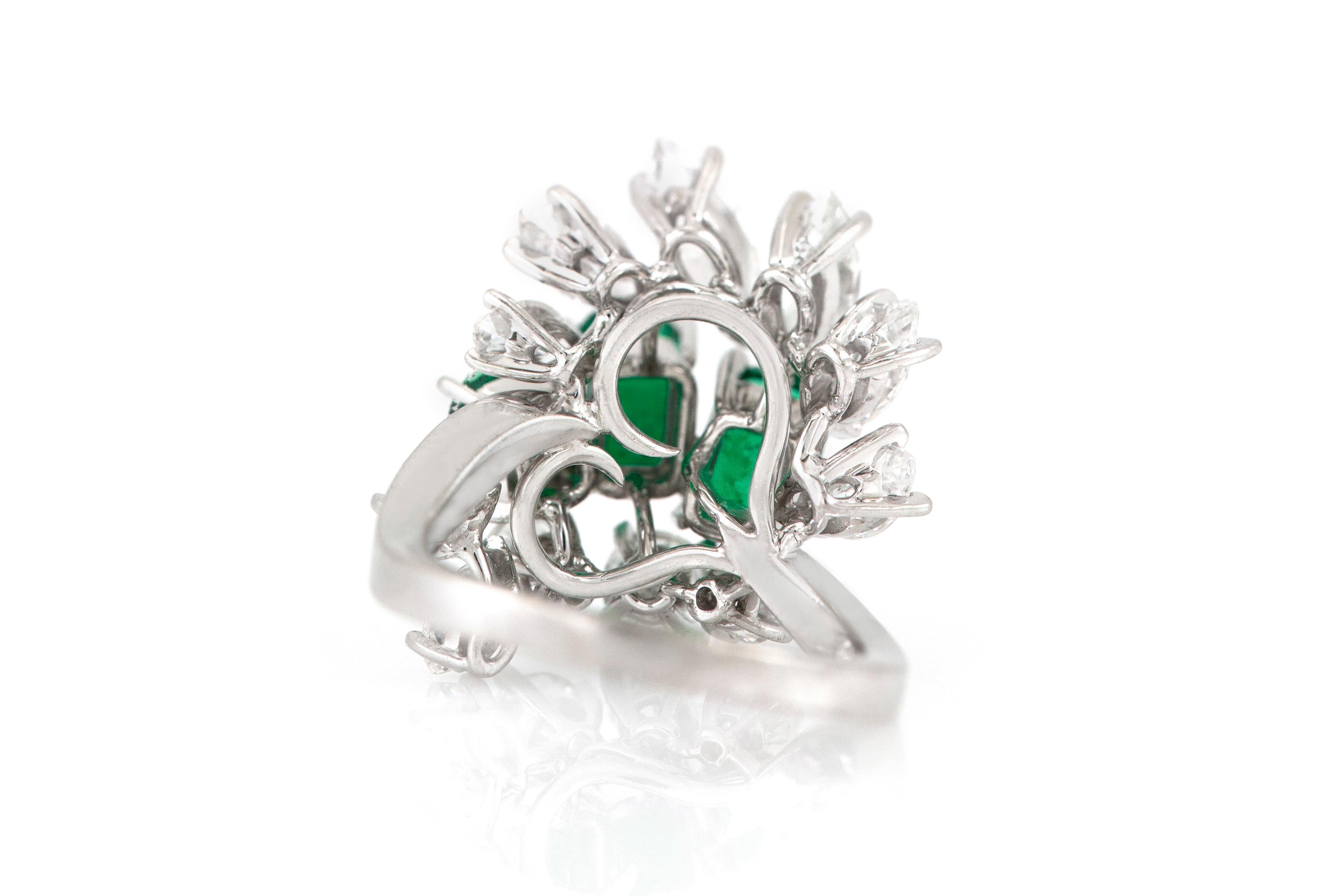 The ring is finely crafted in 18k white gold with emerald weighing approximately total of 2.32 carat. Marquise weighing approximately total of 2.09 carat and diamond weighing approximately total of 0.75 carat. Signed by Meister + paper.