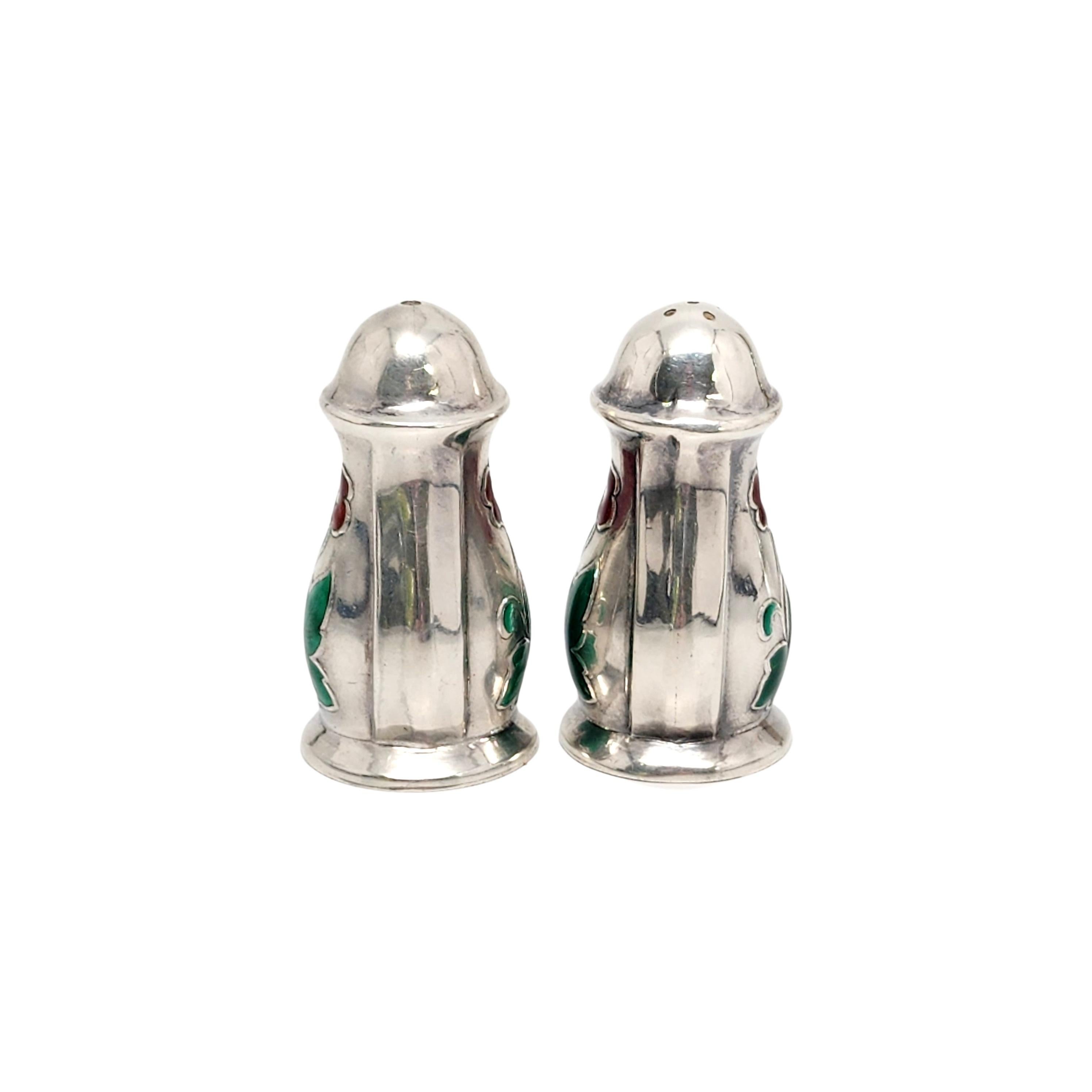 Sterling silver and enamel flower salt and pepper shakers by Meka of Denmark.

Small sterling silver salt and pepper shakers featuring enamel flowers. Salt shaker features 5 holes, pepper shaker features 1 hole. Bottom lids unscrew to
