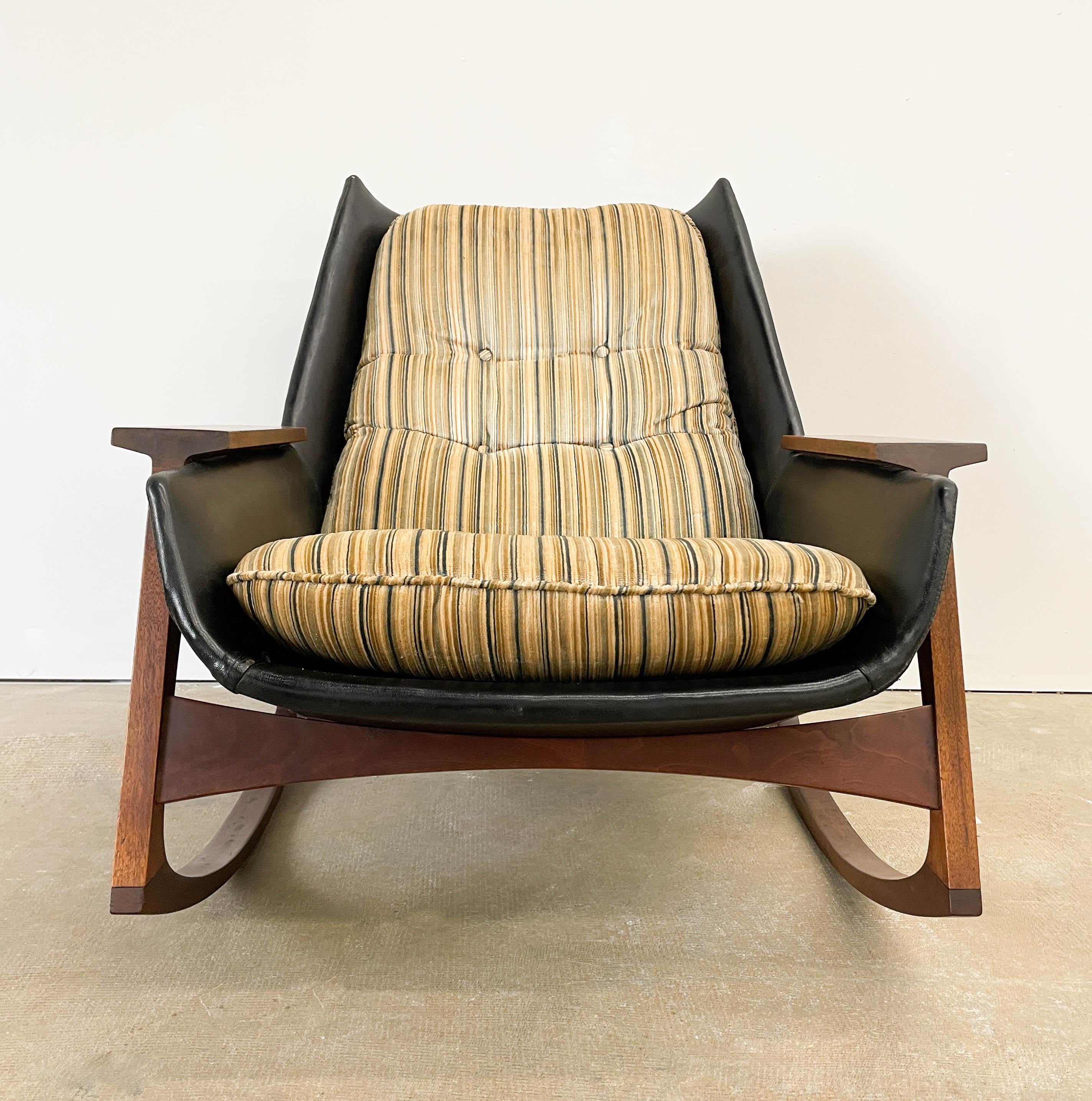 This is a rare Malabar rocking chair designed by Mel Abitz in 1962 for Galloway's of Tampa. A very modern design, this comfortable low rocking chair has great lines, an attractive walnut frame, and a bent plywood shell seat. The original Naugahyde