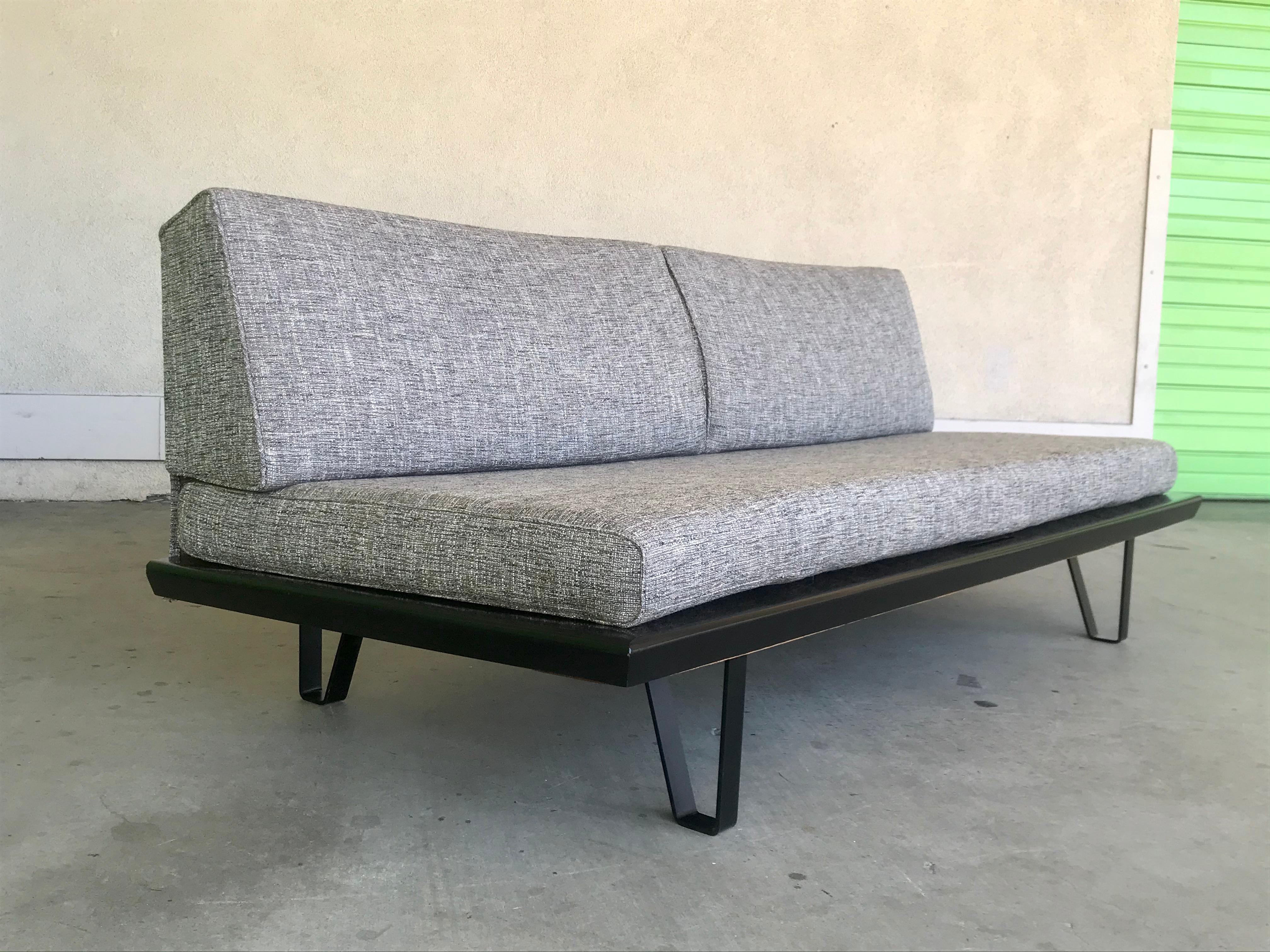 Classic California modern design.
Great for a studio, office, work space et cetra.
Restored a few years ago. 
Iron base, lacquered wood with upholstery.
Original sisal spring net. 
Pulls out 32