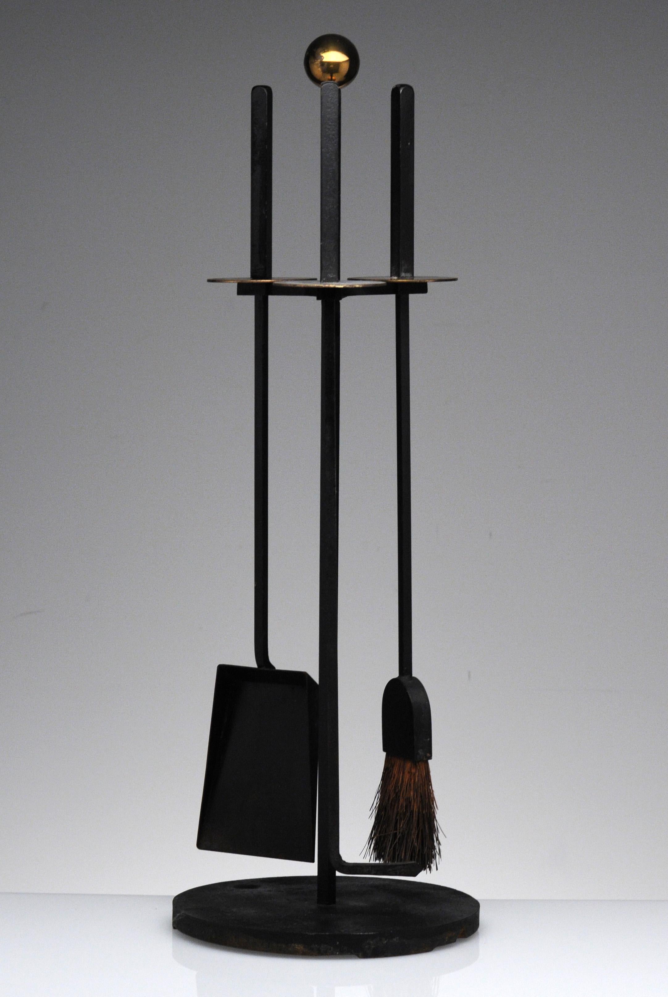 Cast iron and brass Mid-Century Modern design by Mel Bogart for Stewart-Winthrop. Set includes hearth broom, poker, shovel and stand. Good Design paper label to underside.