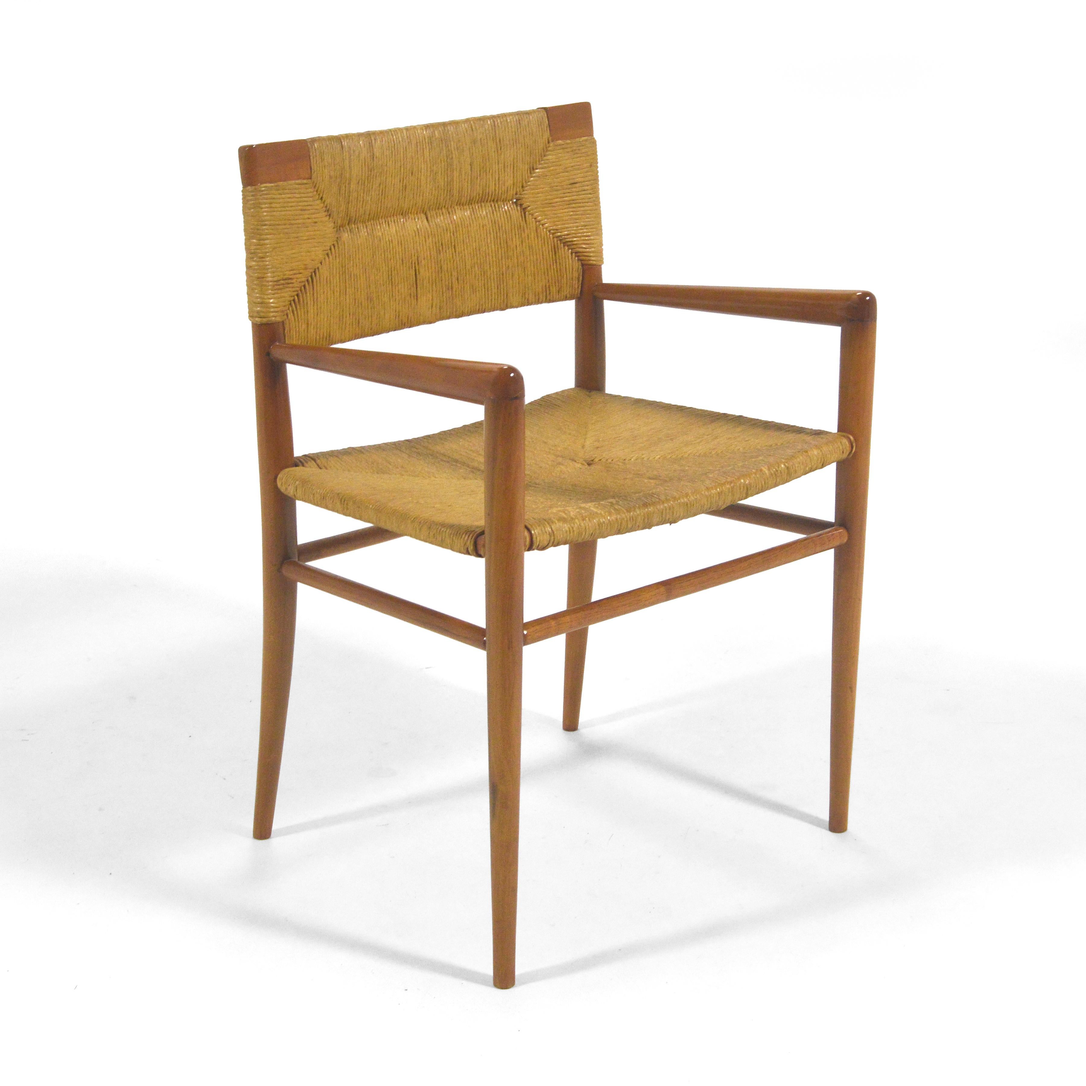 The subtle, almost austere design of Mel Smilow's lounge chair positions it somewhere between a Scandinavian and French aesthetic. The walnut frame supports a seat and back of woven rush. The rakish, angular design points to its midcentury pedigree.