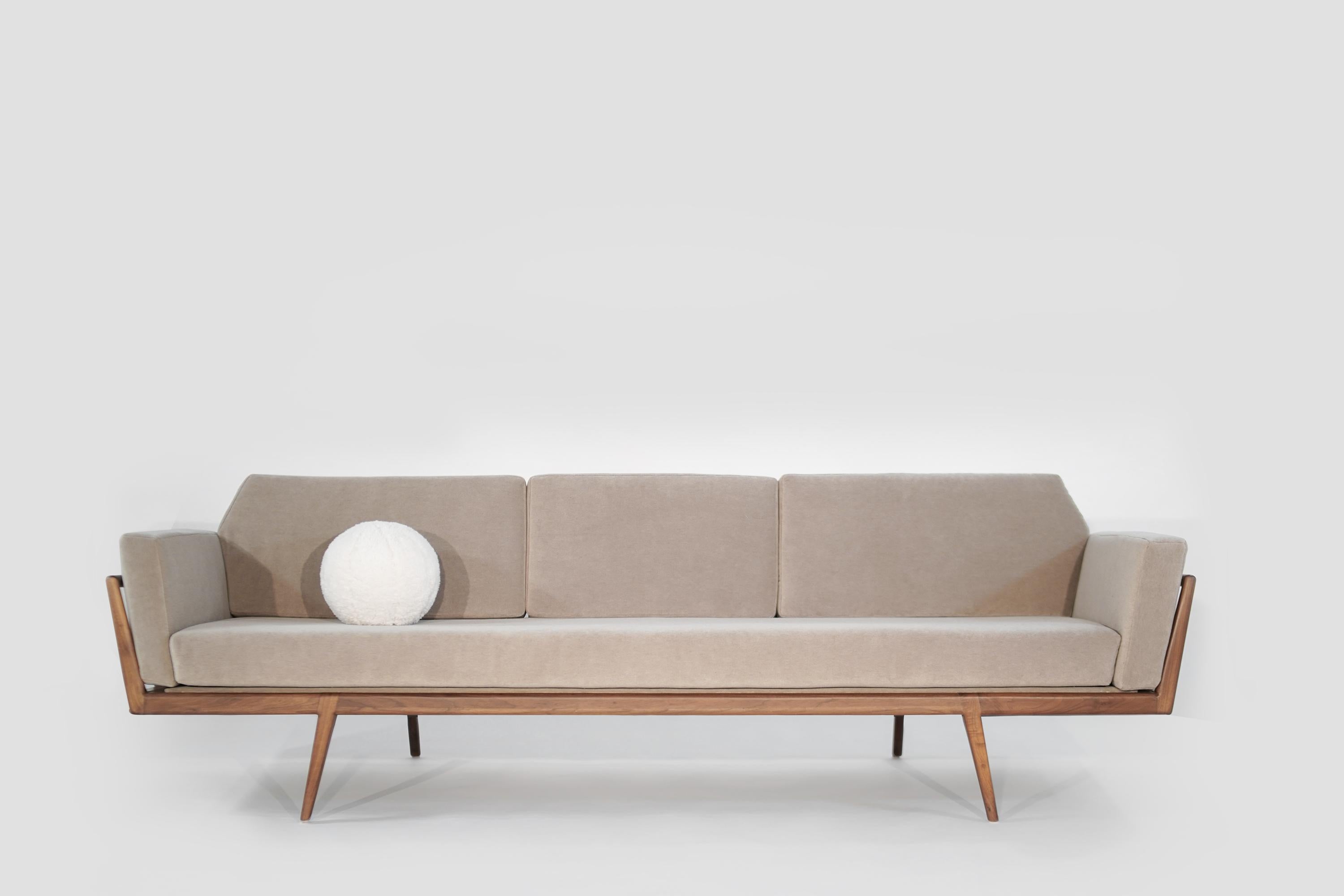 Mel Smilow rail back sofa for Smilow-Thielle in excellent restored condition. The walnut frame has been professionally restored with one of the back legs professionally fixed for stability. The new upholstery boasts hand-cut high-density foam with