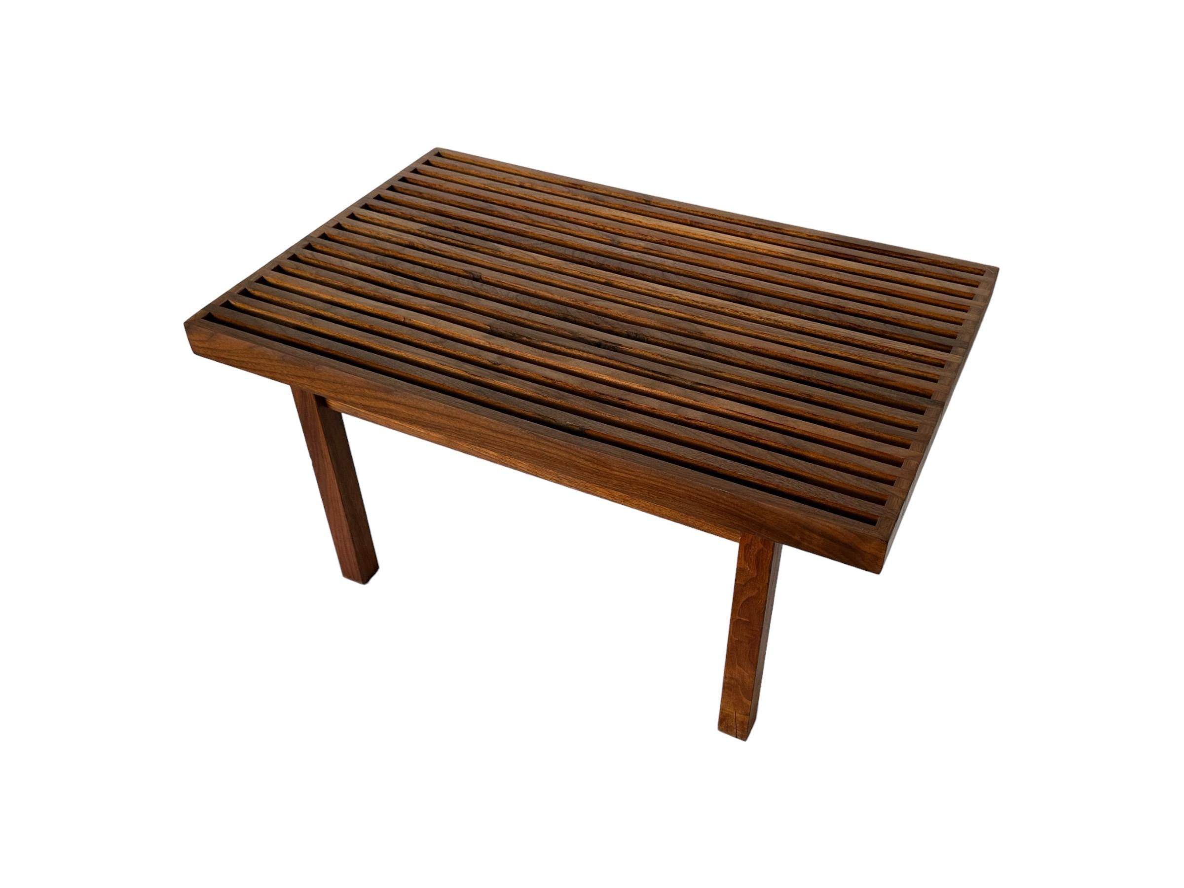 Beautiful Mel Smilow walnut slat bench. Elegant silhouette with simple lines and just the right proportions. Also could be used as a coffee table. Top and sides have been sanded and oiled. Warm attractive nuance in color and grain.