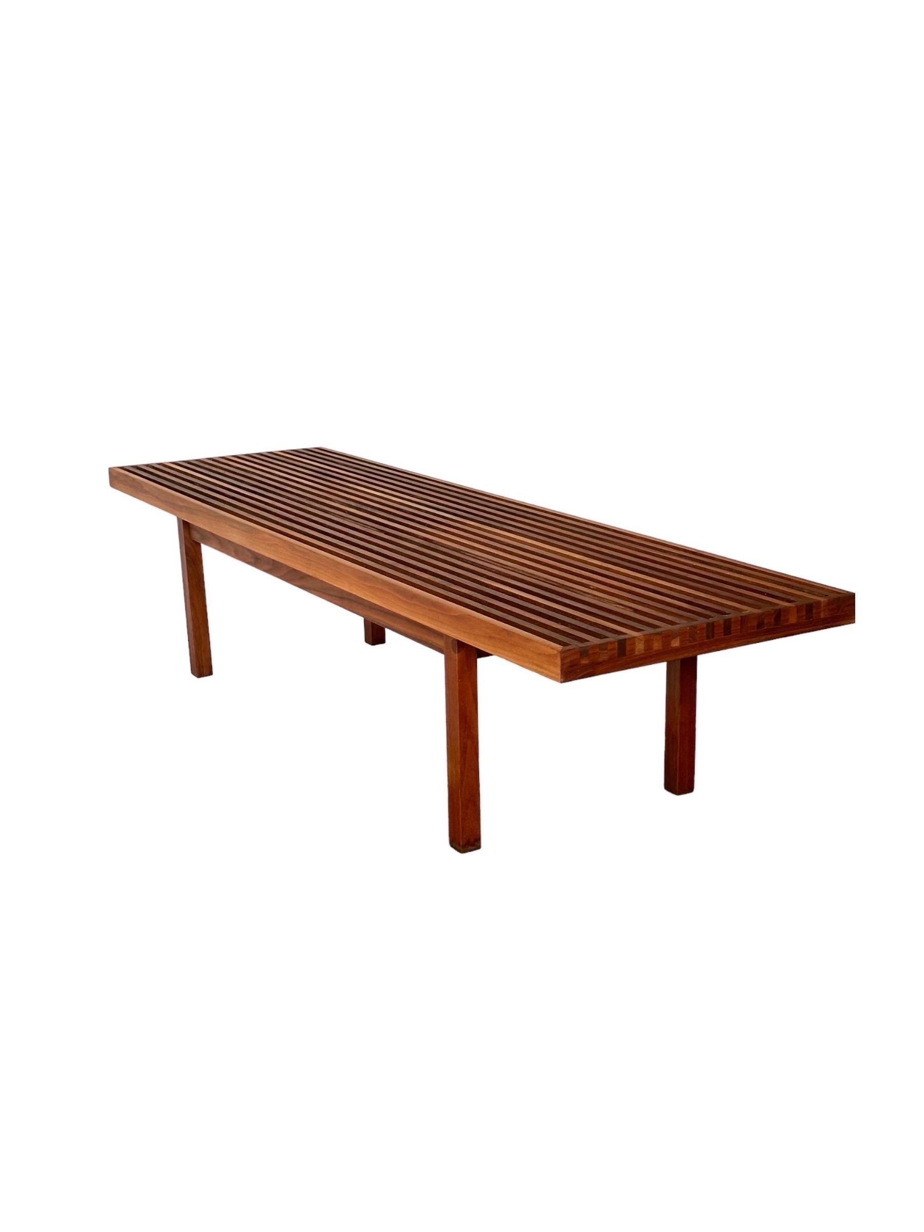 Beautiful Mel Smilow walnut slat bench. Elegant silhouette with simple lines and just the right proportions. Also often used as a coffee table. Top and sides have been sanded and oiled. Warm attractive nuance in color and grain. Measurements: 5’
