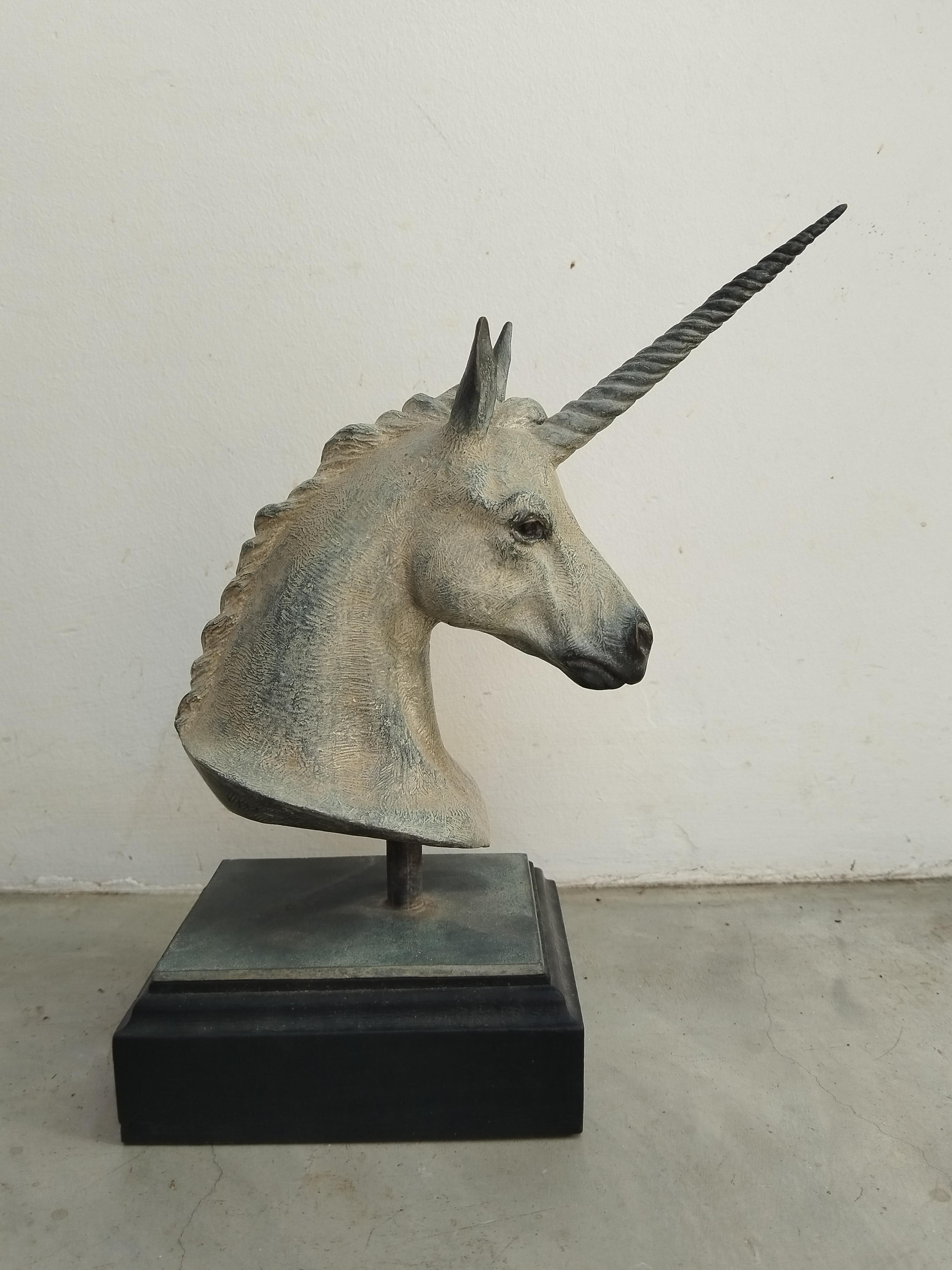 A small, detailed, limited edition bronze sculpture of a unicorn bust a wooden base. Edition 1/12.
