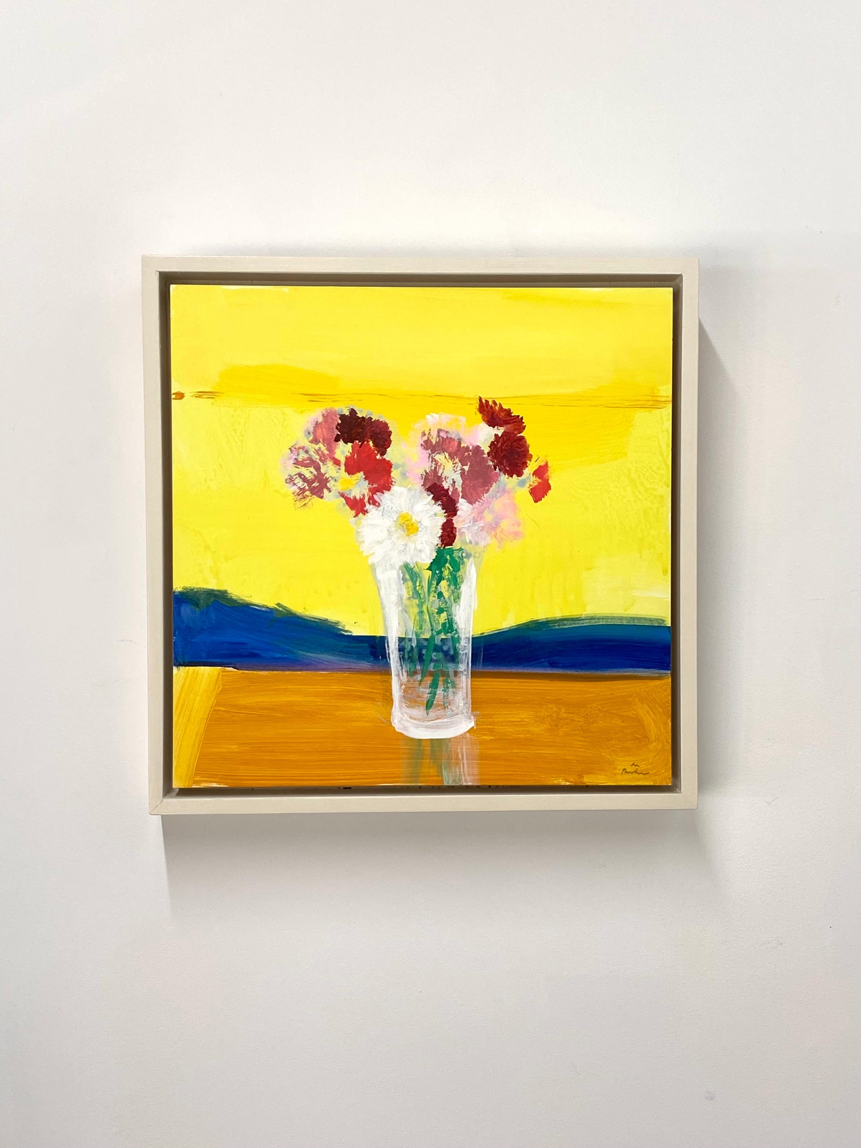 In this contemporary floral still life in acrylic on panel, cheerful white daisies and bright crimson red and pink chrysanthemum flowers with green leaves and stems in a glass on an orange tabletop are beautifully complemented by a cobalt blue and