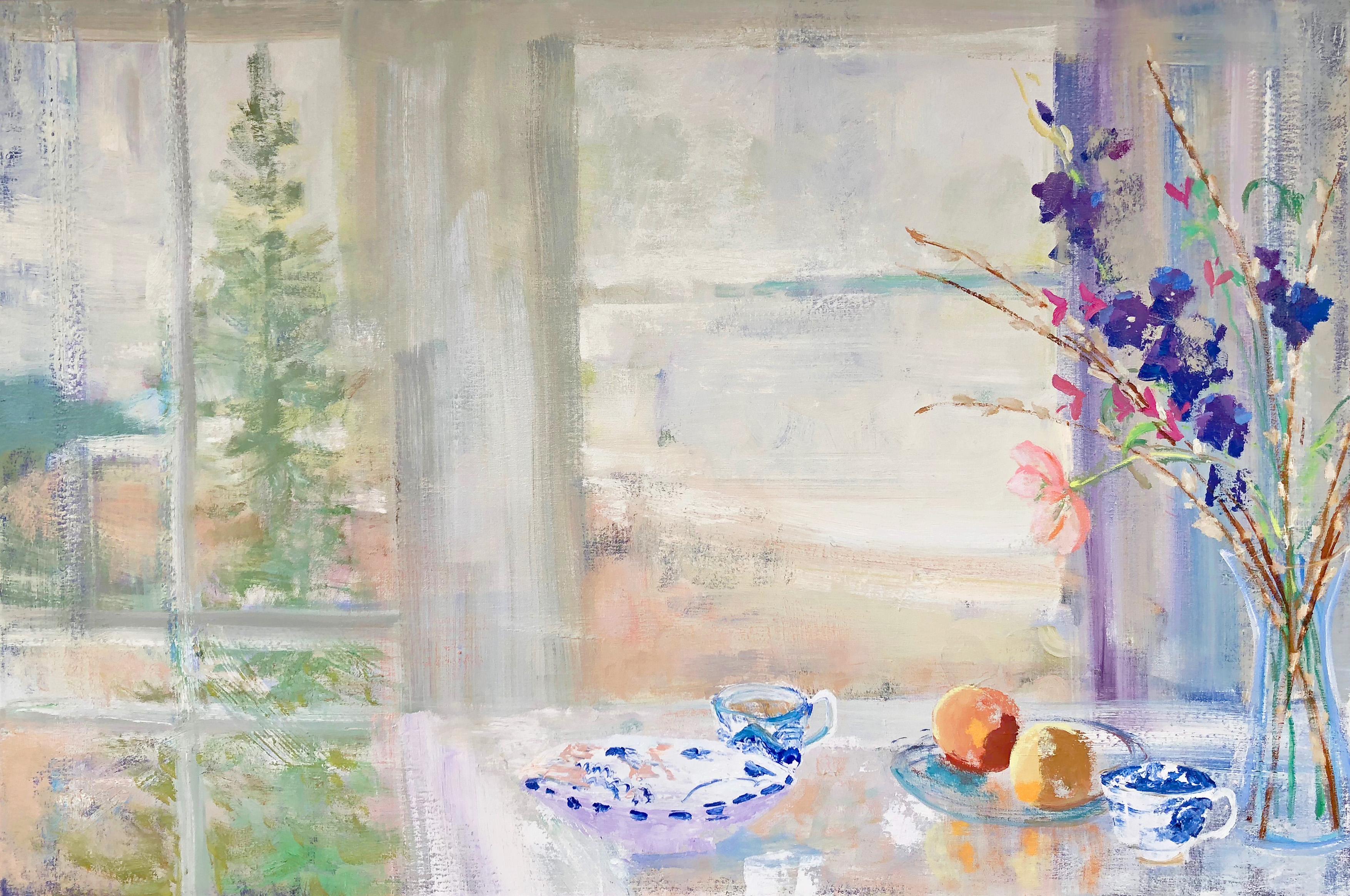 In this light and inviting interior scene, a still life arrangement of flowers and pussy willow in glass vase next to two fruits and two blue and white painted tea cups allude to an afternoon of tea with a loved one. The window in the background