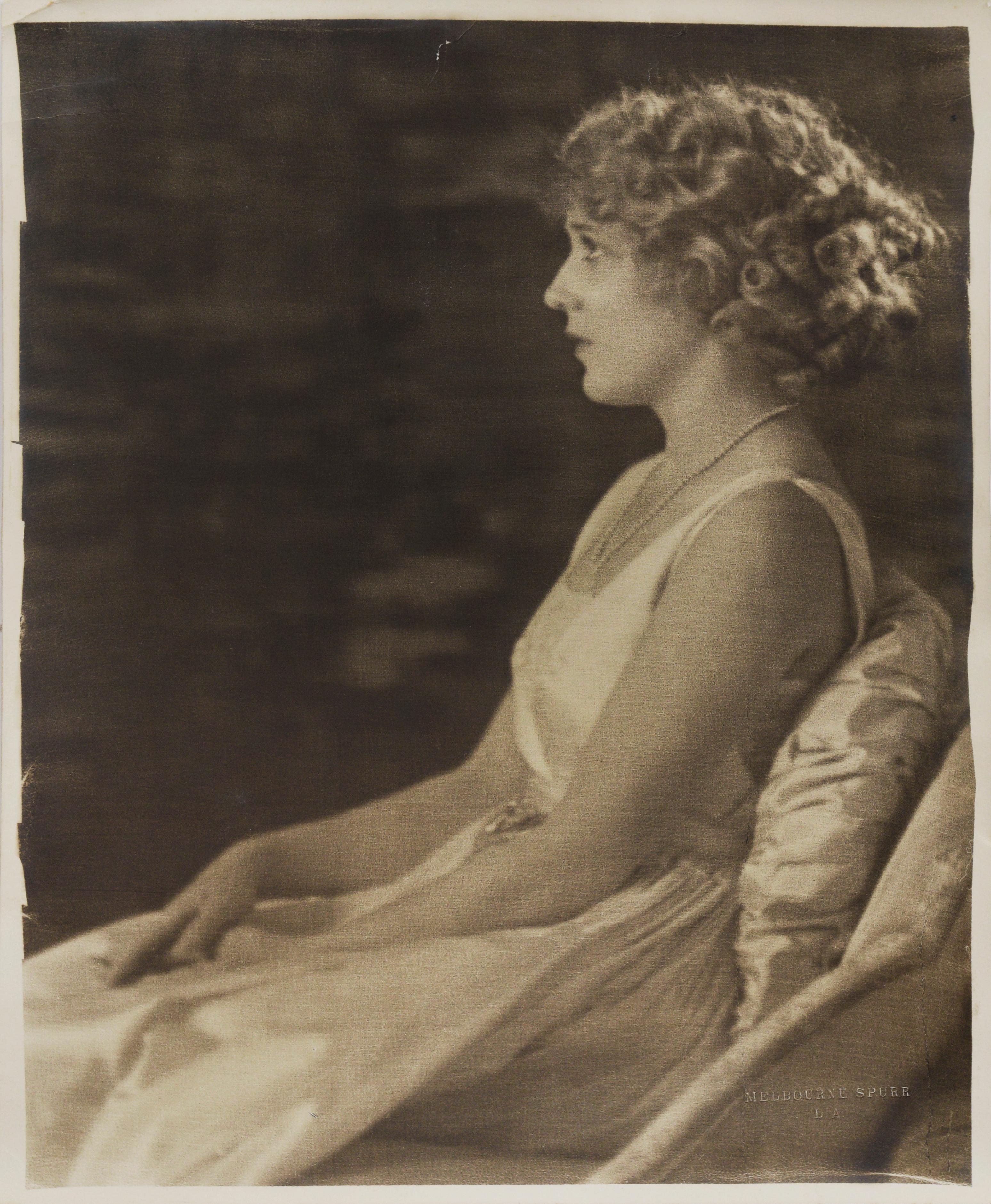 Photograph of Mary Pickford - Melbourne Spurr Photography

Photograph depicting Mary Pickford by Hollywood photographer Melbourne Spurr (Canadian-American, 1892-1979). Mary Pickford is depicted wearing a white sleeveless dress, sitting in a lounge