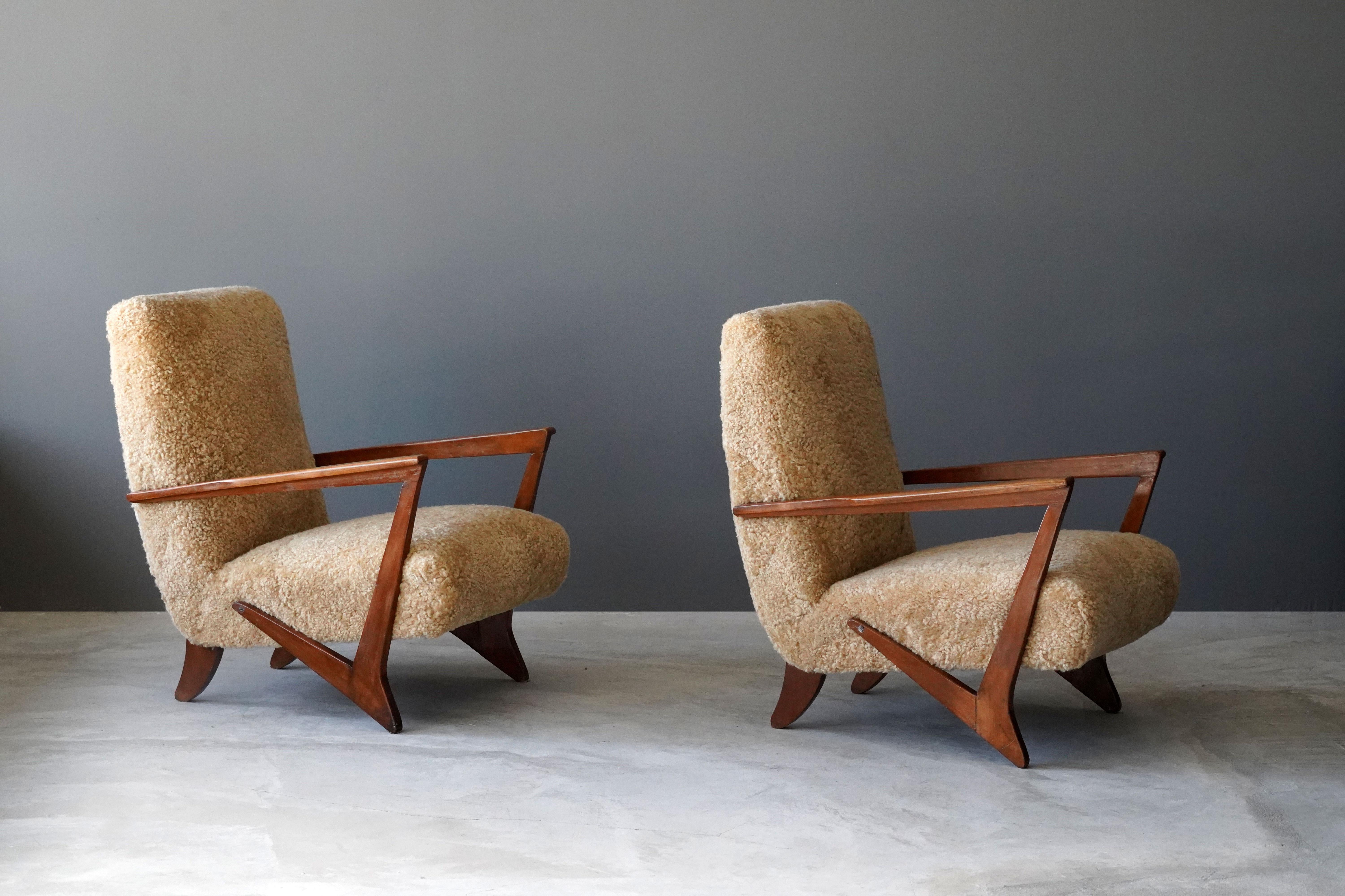 A pair of highly modernist lounge chairs. Designed attributed to Melchiorre Bega, produced 1940s, Italy. Features a highly expressive organic form.

Other designers working in the organic style include: Paolo Buffa, Gio Ponti, Flemming Lassen,