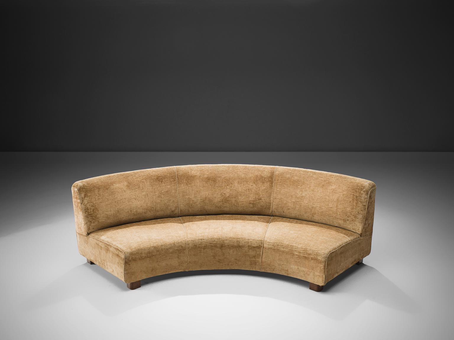 Melchiorre Bega, curved sofa in beige velvet and oak, Italy, circa 1935. 

This large curved sofa which is also used as a centre piece, of a set of other two items, and is made in ocre to beige velvet by Melchiorre Bega. The piece is designed as