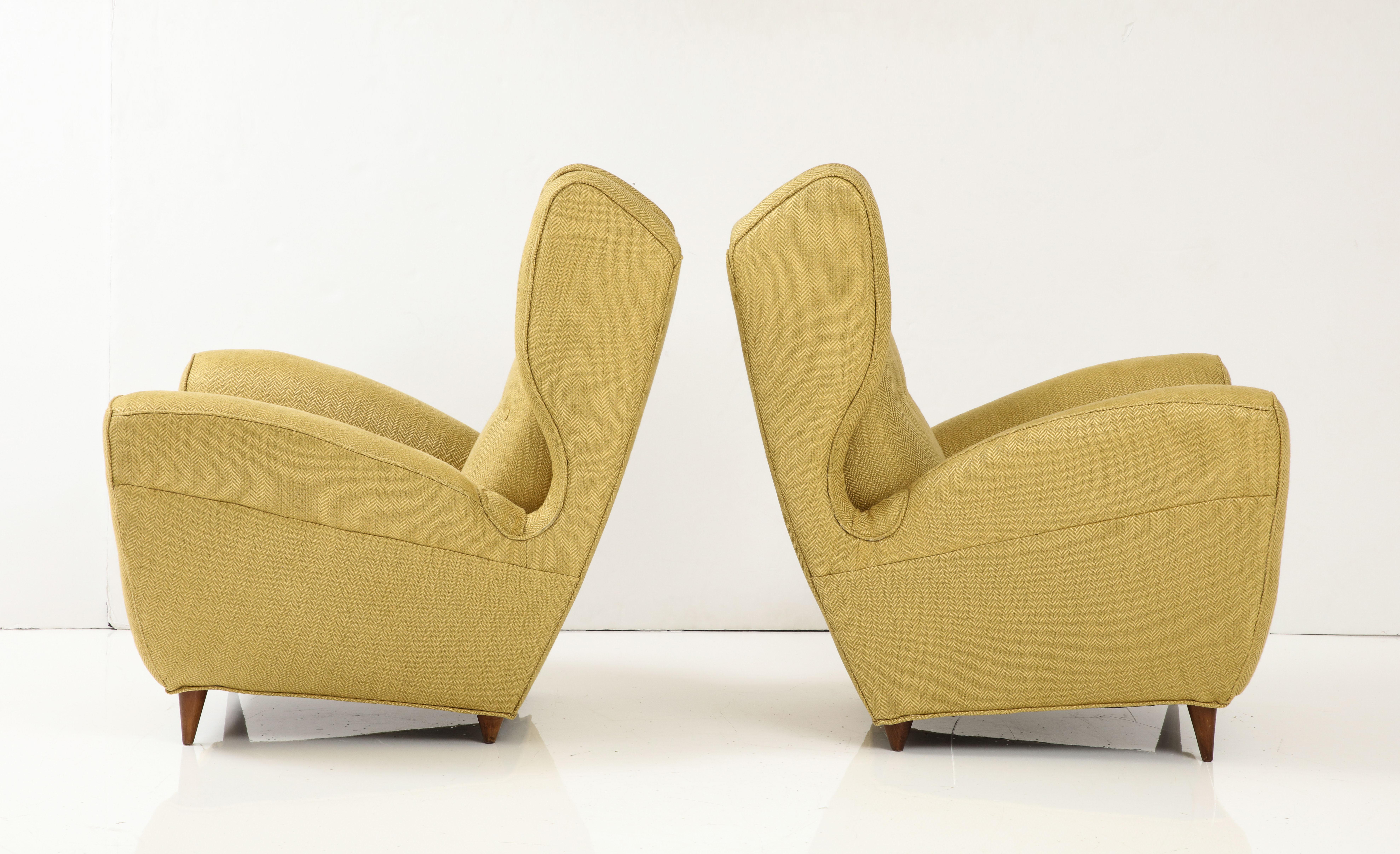 Amazing pair of large 1950's wingback lounge chairs designed by Melchiorre Bega, newly re-upholstered in linen blend Donghia fabric, with minor wear and patina due to age and use.