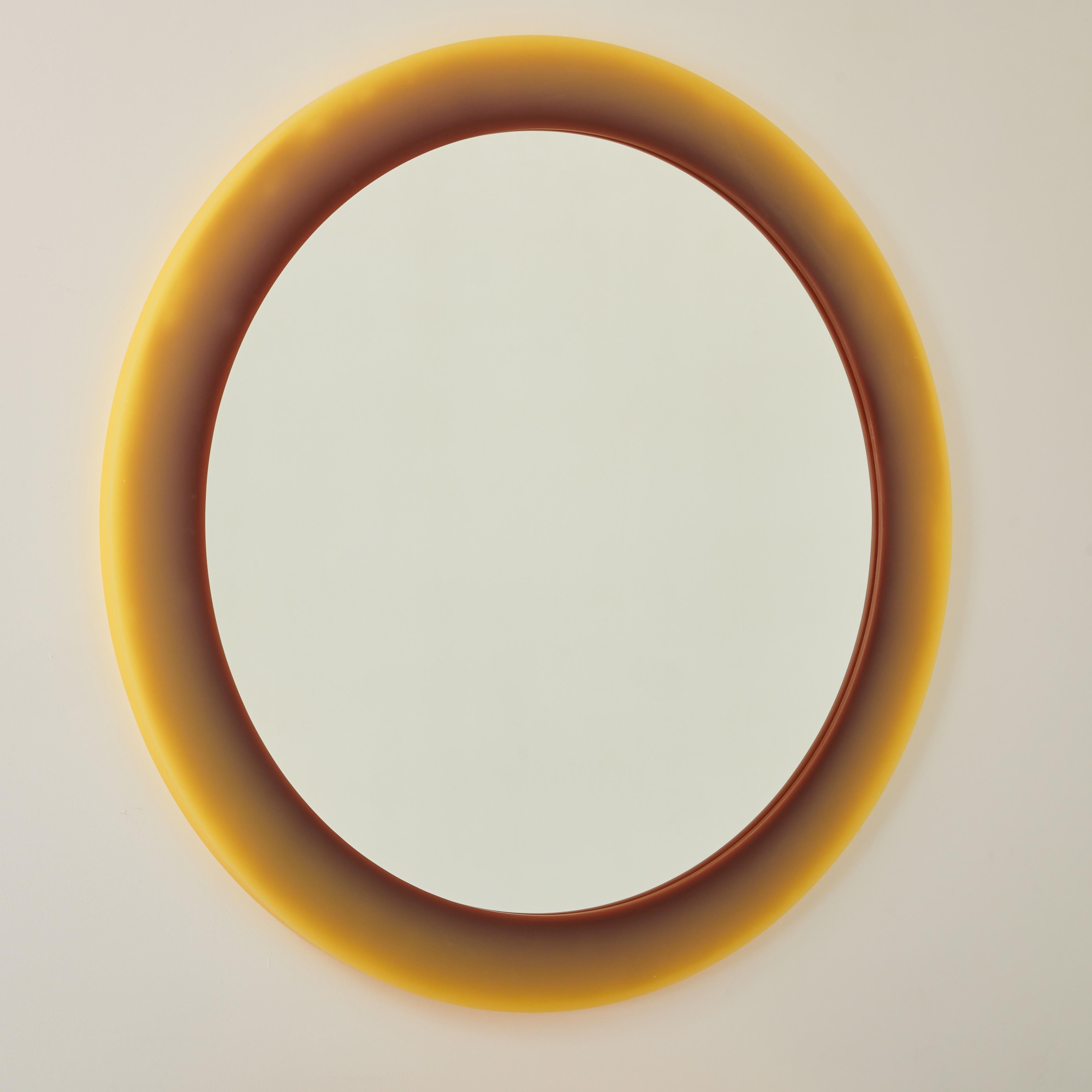 Unique wall mirror with a resin sculpted frame to create a halo of shifting color. The SHIFT technique creates an illusion of a glowing effect, featuring a subtle saturation shift from taupe to golden wheat by manipulating the visual interaction