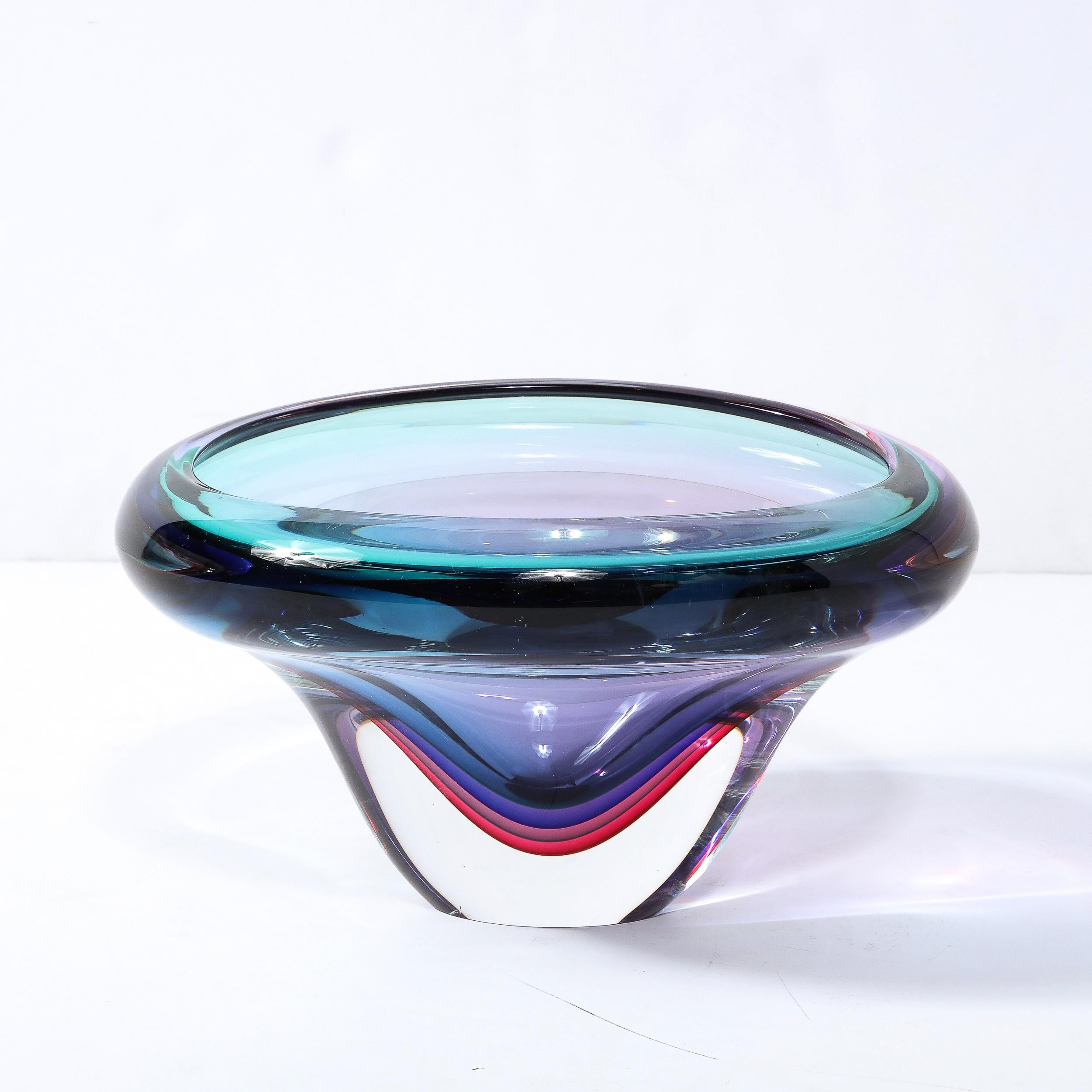 This stunning modernist glass bowl was realized by the esteemed studio of Signoretti in Murano, Italy- the island off the coast of Venice renowned for centuries for its superlative glass production- circa 2010. It features an elliptical form with a