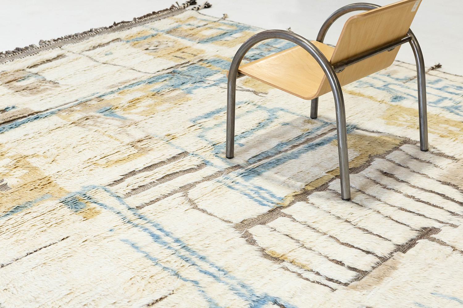 Meliska' is a beautifully textured rug with irregular motifs inspired from the Atlas Mountains of Morocco. Natural blush, golden yellow, and blue surrounded by ivory shag work cohesively to make for a great contemporary interpretation for the modern