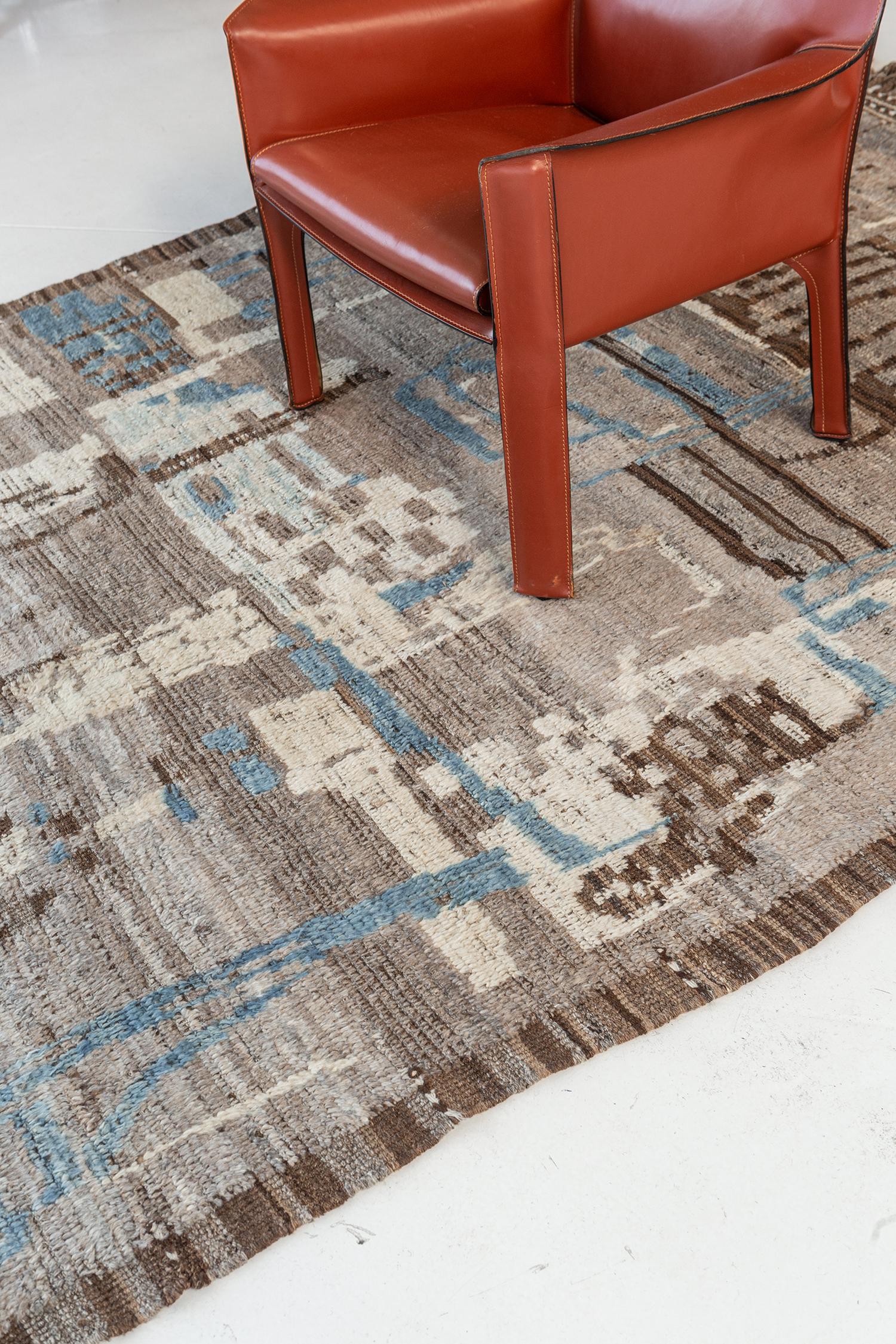 Meliska is a captivating textured rug with irregular motifs inspired by the Atlas Mountains of Morocco. Earthy tones of ivory, blue, and chocolate brown surrounded by umber brown shag work cohesively to make for a great contemporary interpretation