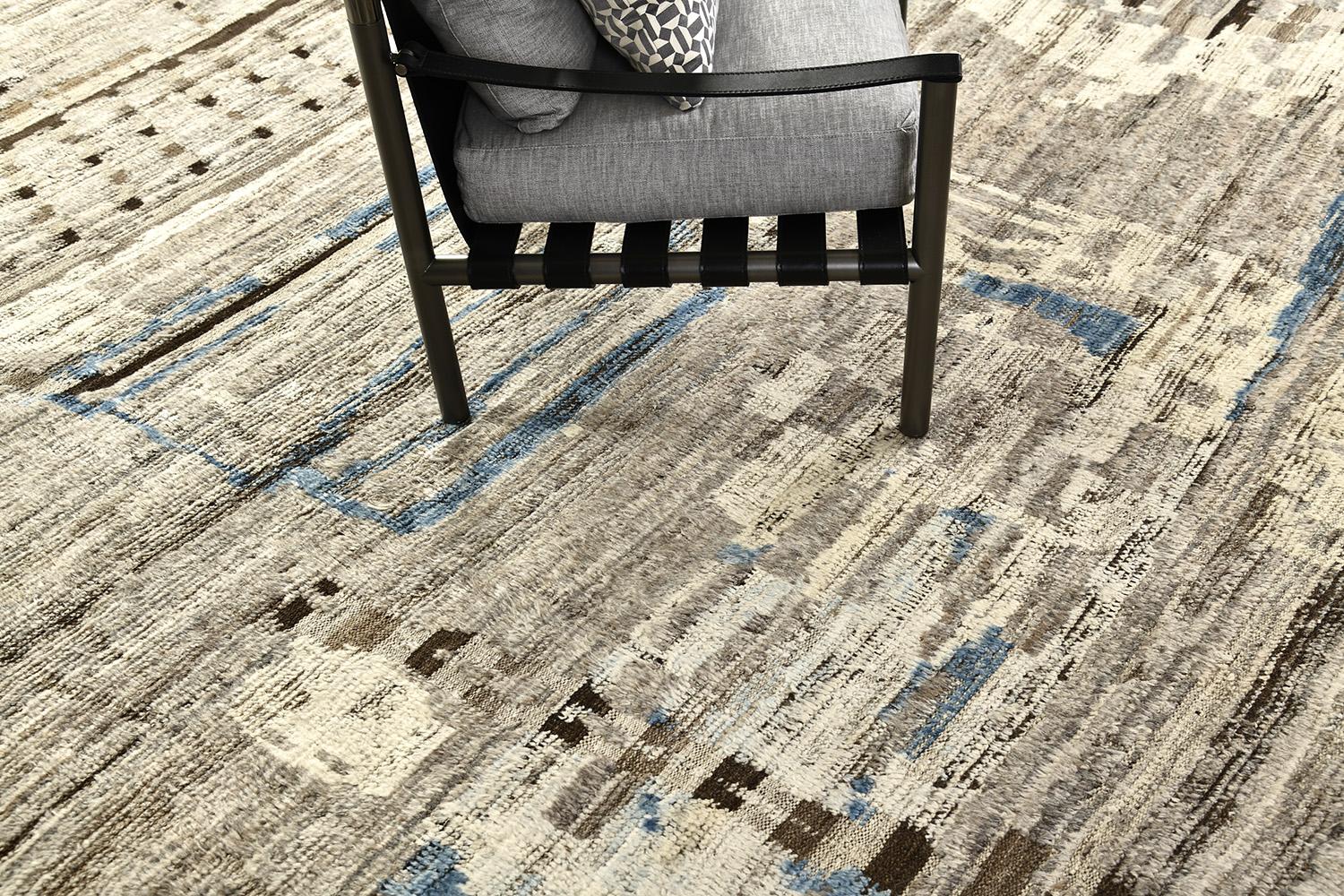 'Meliska' is an exquisitely textured rug with irregular motifs inspired from the Atlas Mountains of Morocco. Earthy tones of ivory and chocolate brown surrounded by umber brown shag work cohesively to make for a great contemporary interpretation for