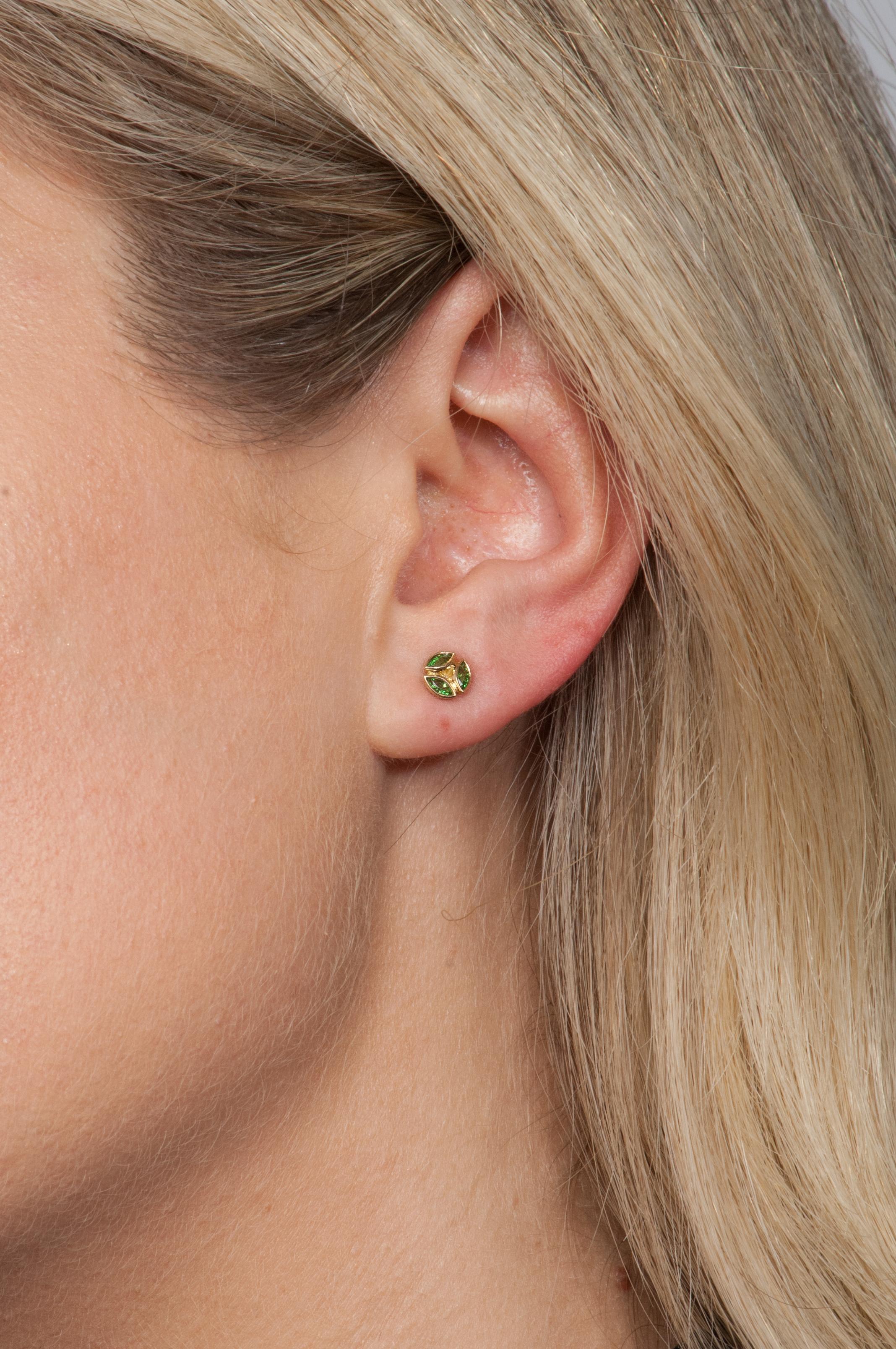 These delicate tsavorite studs are an easy everyday choice. Wear alone for a classic look or stack above your favorite hoops.

18K yellow gold with tsavorites (0.46tcw)
0.24” diameter
