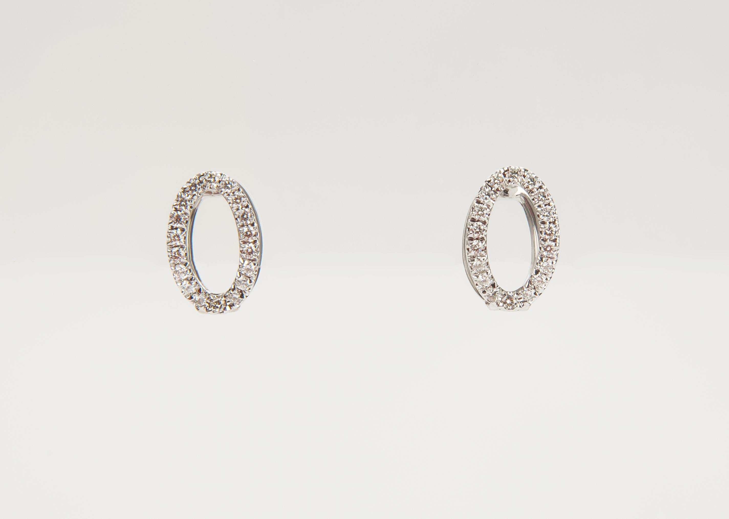 Designed as open ovals, these delicate diamond earrings curve gracefully around your lobe and are scaled to layer with other studs or cuffs.

18K white gold
Pave diamonds (0.53tcw)
Hinged hoop with post back
0.60” long