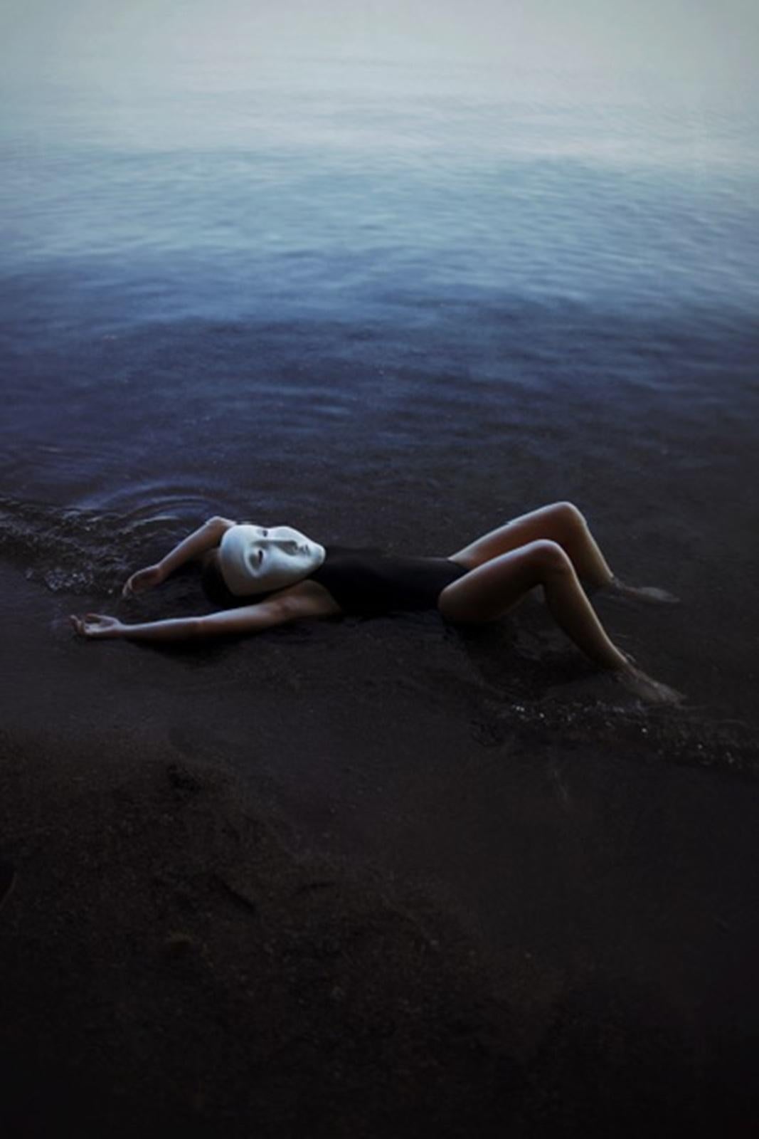 Melissa Meier Portrait Photograph – Mask Lying in the Water