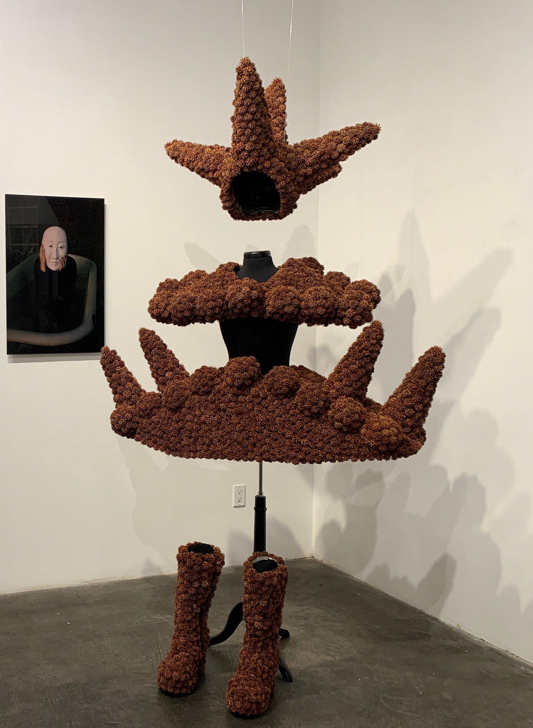 Wearable sculpture created with sweet gum balls. Dimensions variable depending upon how the work is hung/displayed.