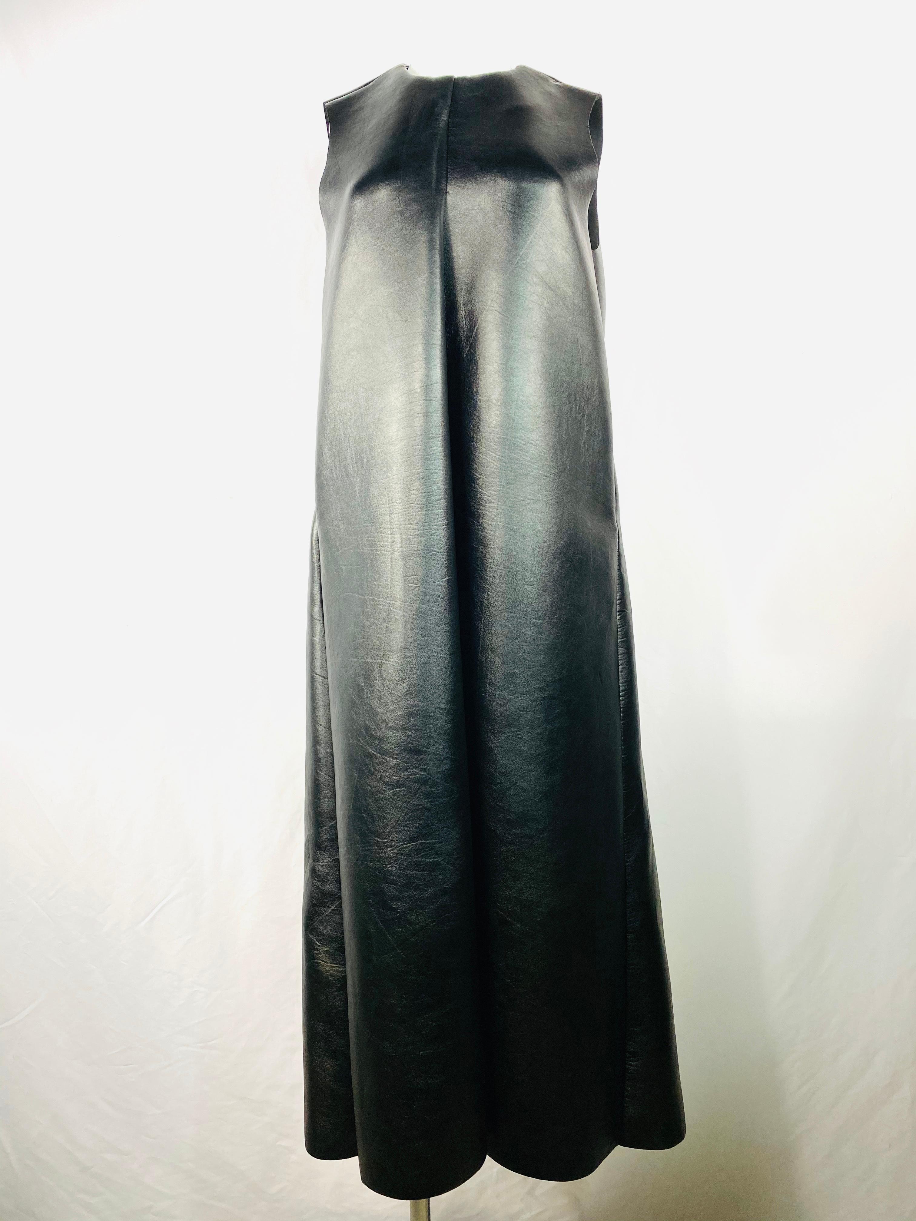 Product details:

Featuring flack faux leather, sleeveless, crew neck, pocket on each side, rear zip closure, maxi dress. 
Size M.
Made in USA.