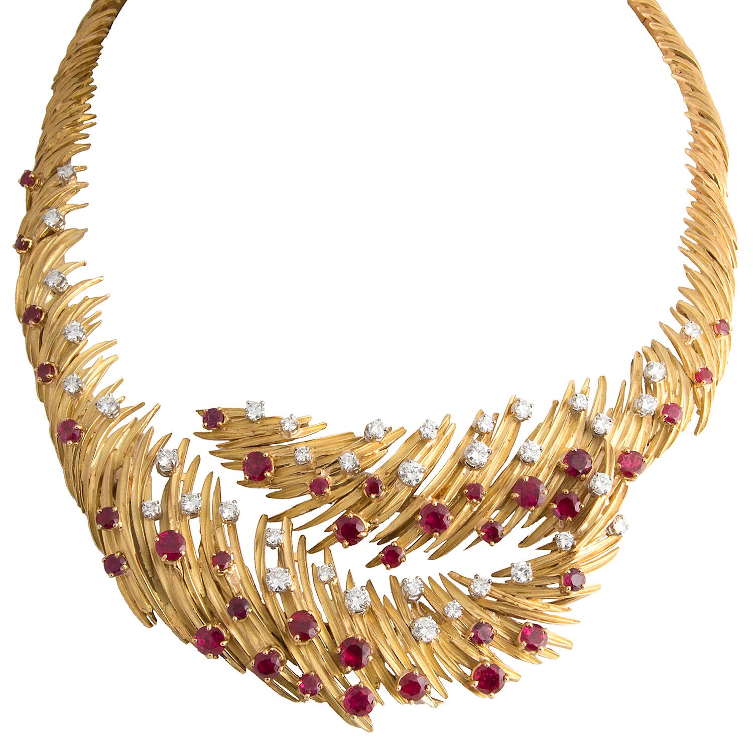 A very Important 5-piece parure by Mellerio 'dit Meller' Paris, designed as stylised feathers, in 18k mat and polished yellow gold set with over 40 Cts Burmese rubies and app. 25-30 Cts of brilliant cut diamonds. Compromising a bombé ring,  a pair